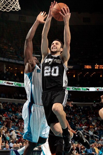 NEW ORLEANS - NOVEMBER 28:  Manu Ginobili #20 of the San Antonio Spurs shoots the ball over Emeka Okafor #50 of the New Orleans Hornets at the New Orleans Arena on November 28, 2010 in New Orleans, Louisiana.  The Spurs defeated the Hornets 109-95.  NOTE