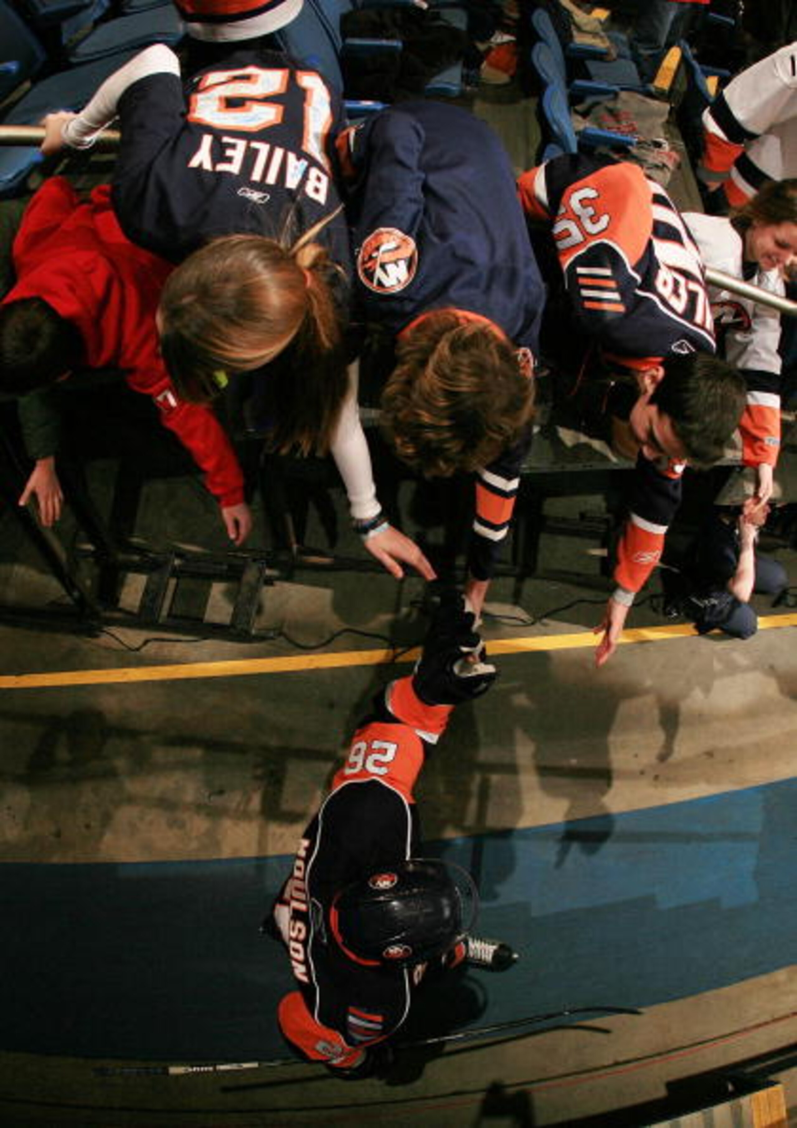 UNIONDALE, NY - JANUARY 12:  Fans greet Matt Moulson #26 of the New York Islanders as he walks to the ice before the game against the Detroit Red Wings at the Nassau Coliseum on January 12, 2010 in Uniondale, New York.  (Photo by Bruce Bennett/Getty Image