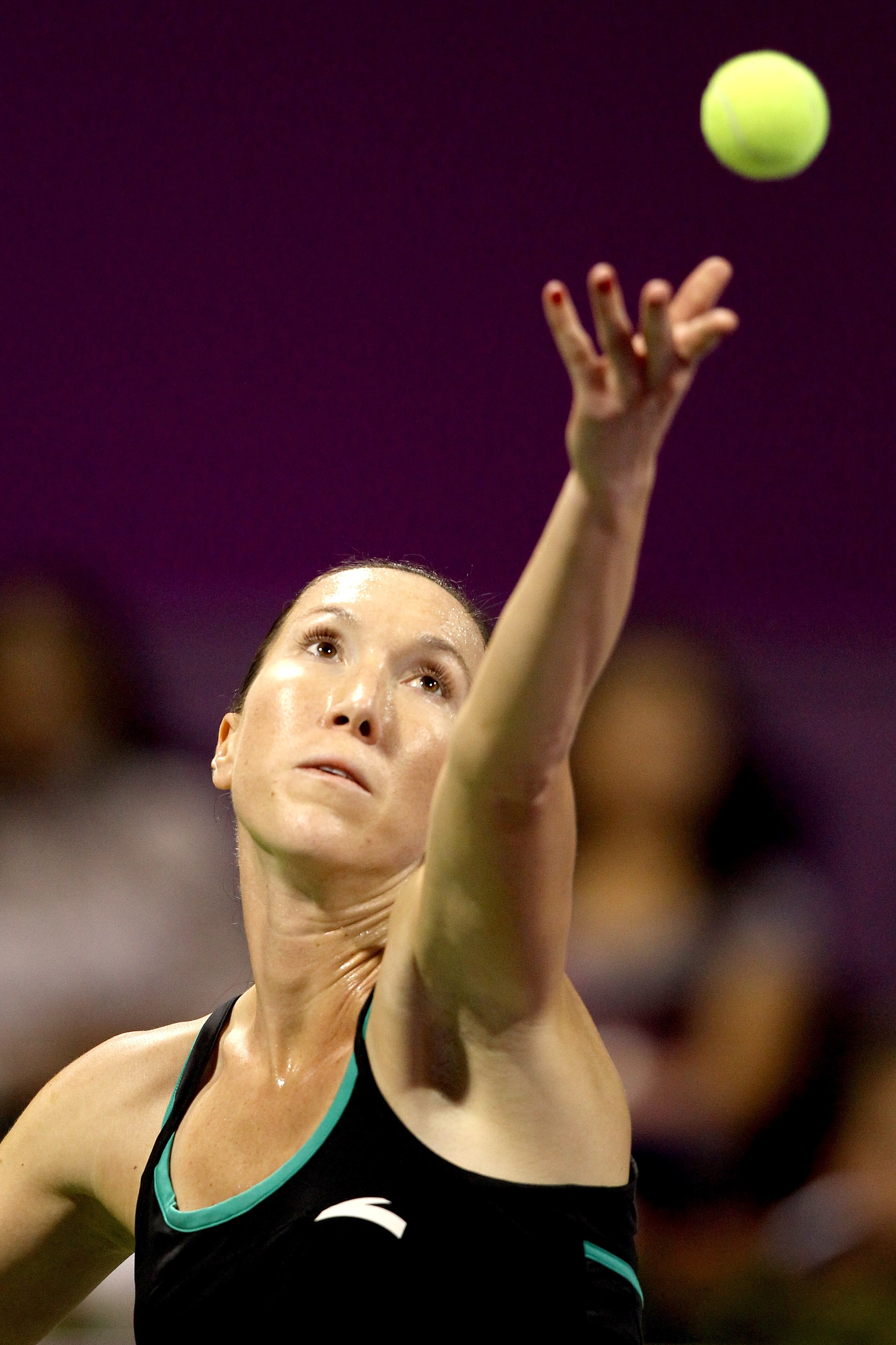 DOHA, QATAR - OCTOBER 29:  Jelena Jankovic of Serbia serves to Victoria Azarenka of Belarus during day four of the WTA Championships at the Khalifa Tennis Complex on October 29, 2010 in Doha, Qatar.  (Photo by Matthew Stockman/Getty Images)