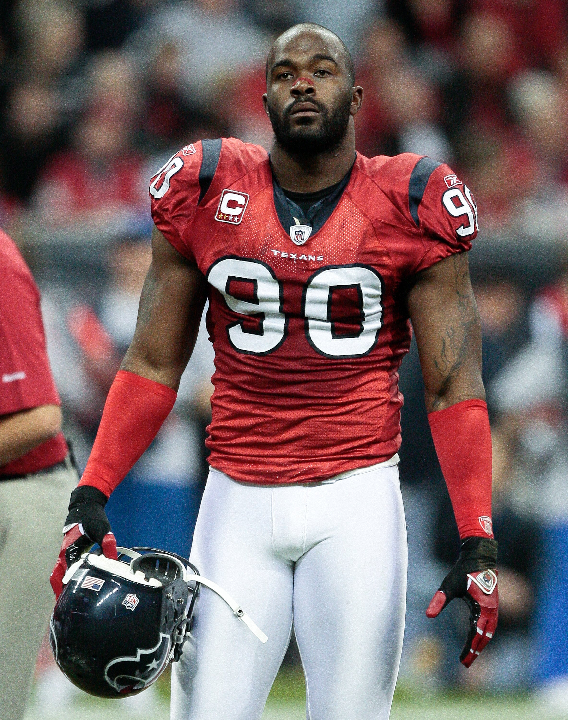 HOUSTON - NOVEMBER 23:  Defensive end Mario Williams #90 of the Houston Texans walks back to the locker room after pre-game warm ups at Reliant Stadium on November 23, 2009 in Houston, Texas.  (Photo by Bob Levey/Getty Images)
