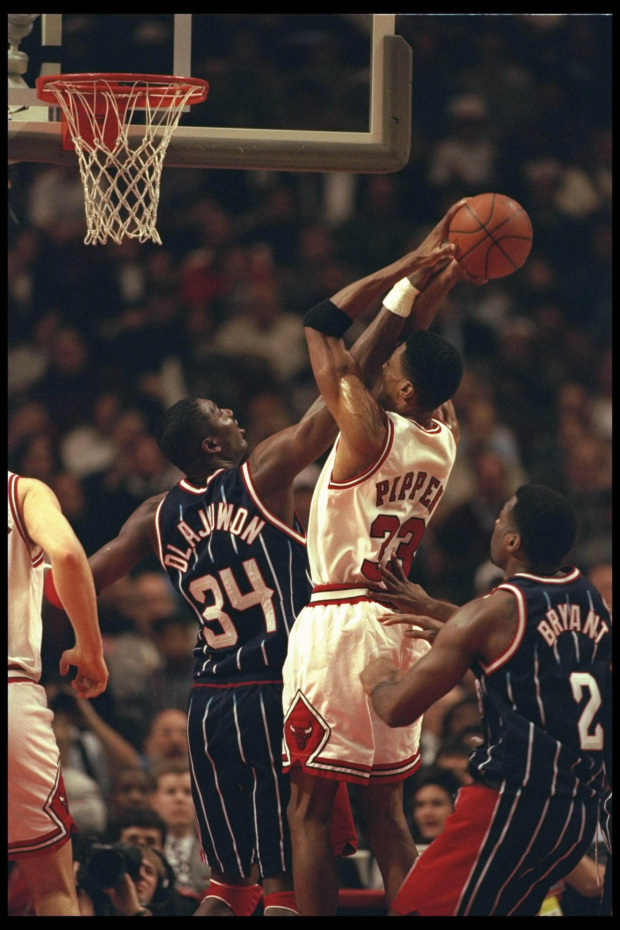 3 Jan 1996:  Center Hakeem Olajuwon of the Houston Rockets and guard Scottie Pippen of the Chicago Bulls fight for the ball during a game played at the United Center in Chicago, Illinois.  The Bulls won the game, 100-86. Mandatory Credit: Jonathan Daniel