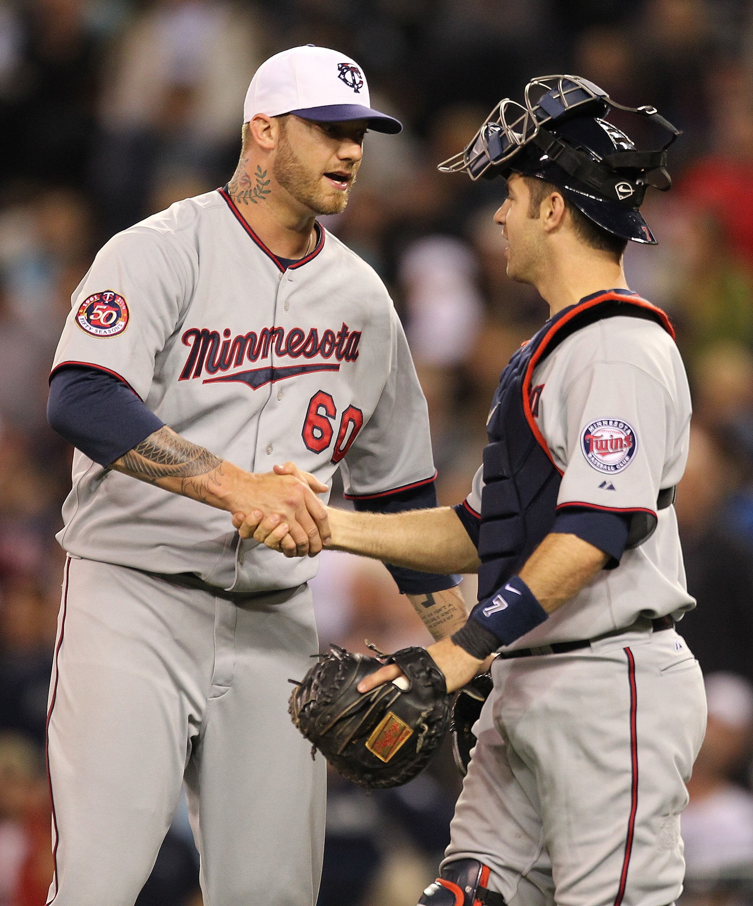 SEATTLE - MAY 31:  Closer Jon Rauch #60 of the Minnesota Twins celebrates with catcher Joe Mauer #7 after defeating the Seattle Mariners 5-4 at Safeco Field on May 31, 2010 in Seattle, Washington. (Photo by Otto Greule Jr/Getty Images)