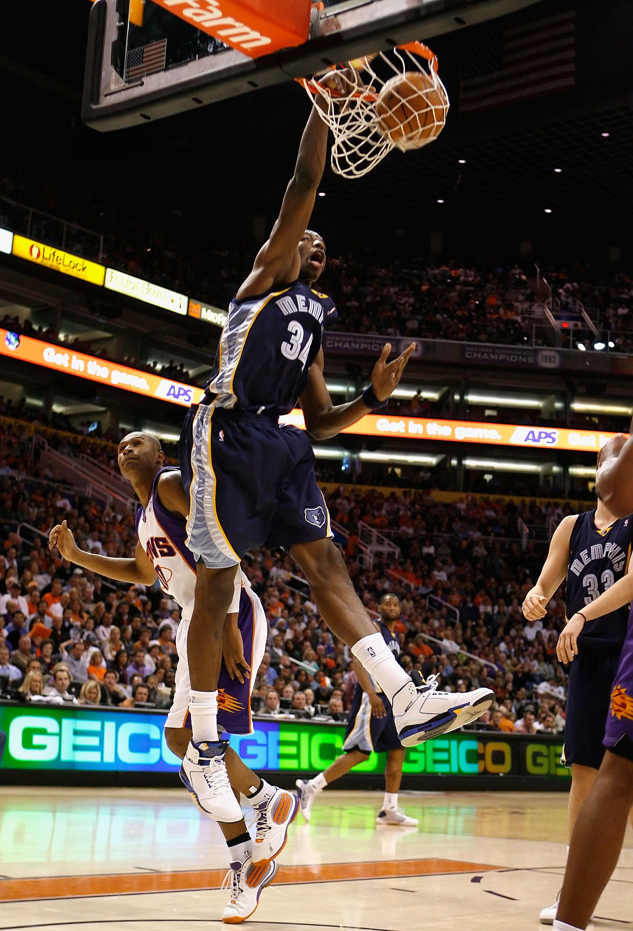 PHOENIX - NOVEMBER 25:  Hasheem Thabeet #34 of the Memphis Grizzlies slam dunks the ball over Leandro Barbosa #10 of the Phoenix Suns during the NBA game at US Airways Center on November 25, 2009 in Phoenix, Arizona. NOTE TO USER: User expressly acknowled