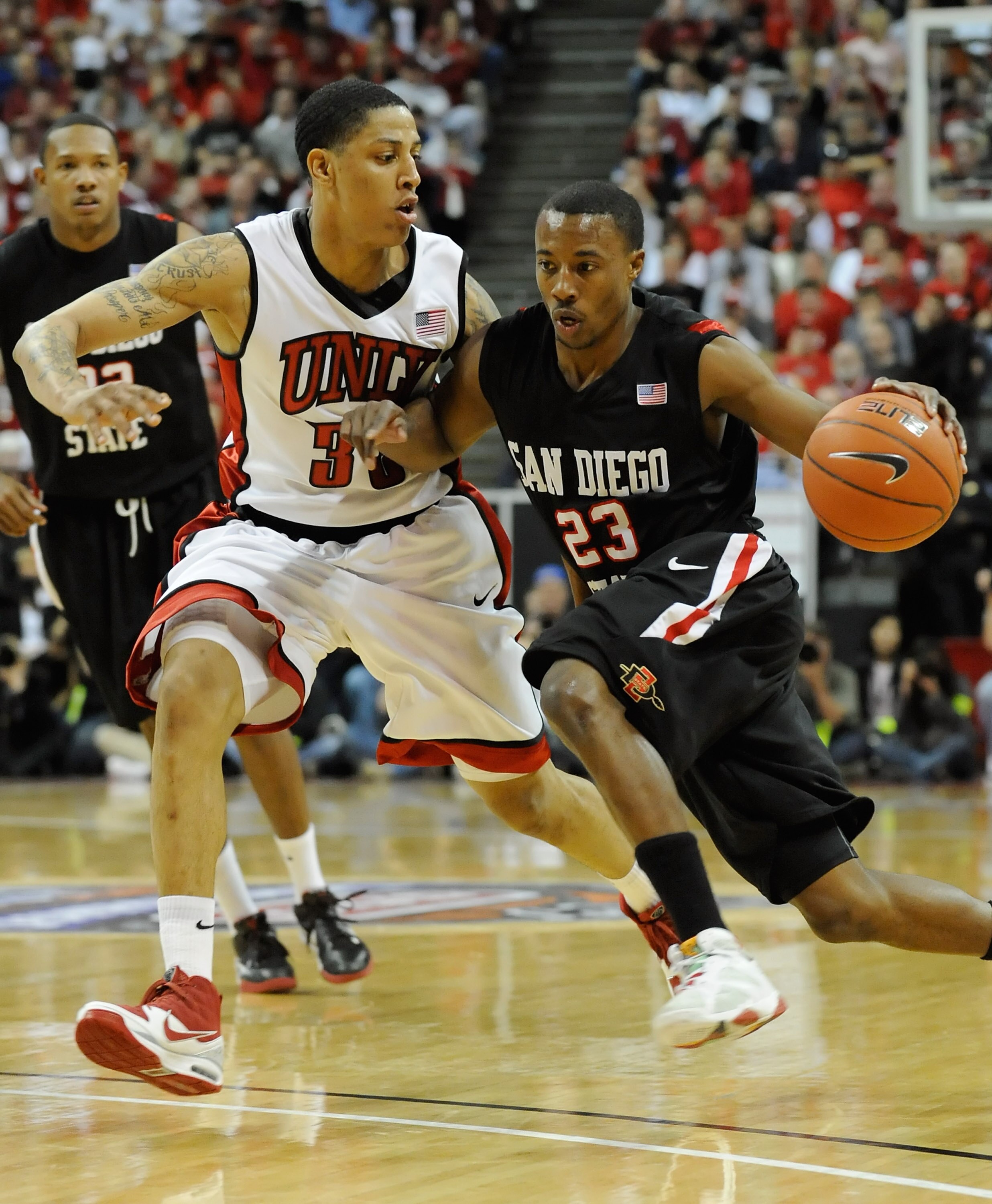 LAS VEGAS - MARCH 13:  D.J. Gay #23 of the San Diego State Aztecs drives against Tre'Von Willis #33 of the UNLV Rebels during the championship game of the Conoco Mountain West Conference Basketball tournament at the Thomas & Mack Center March 13, 2010 in