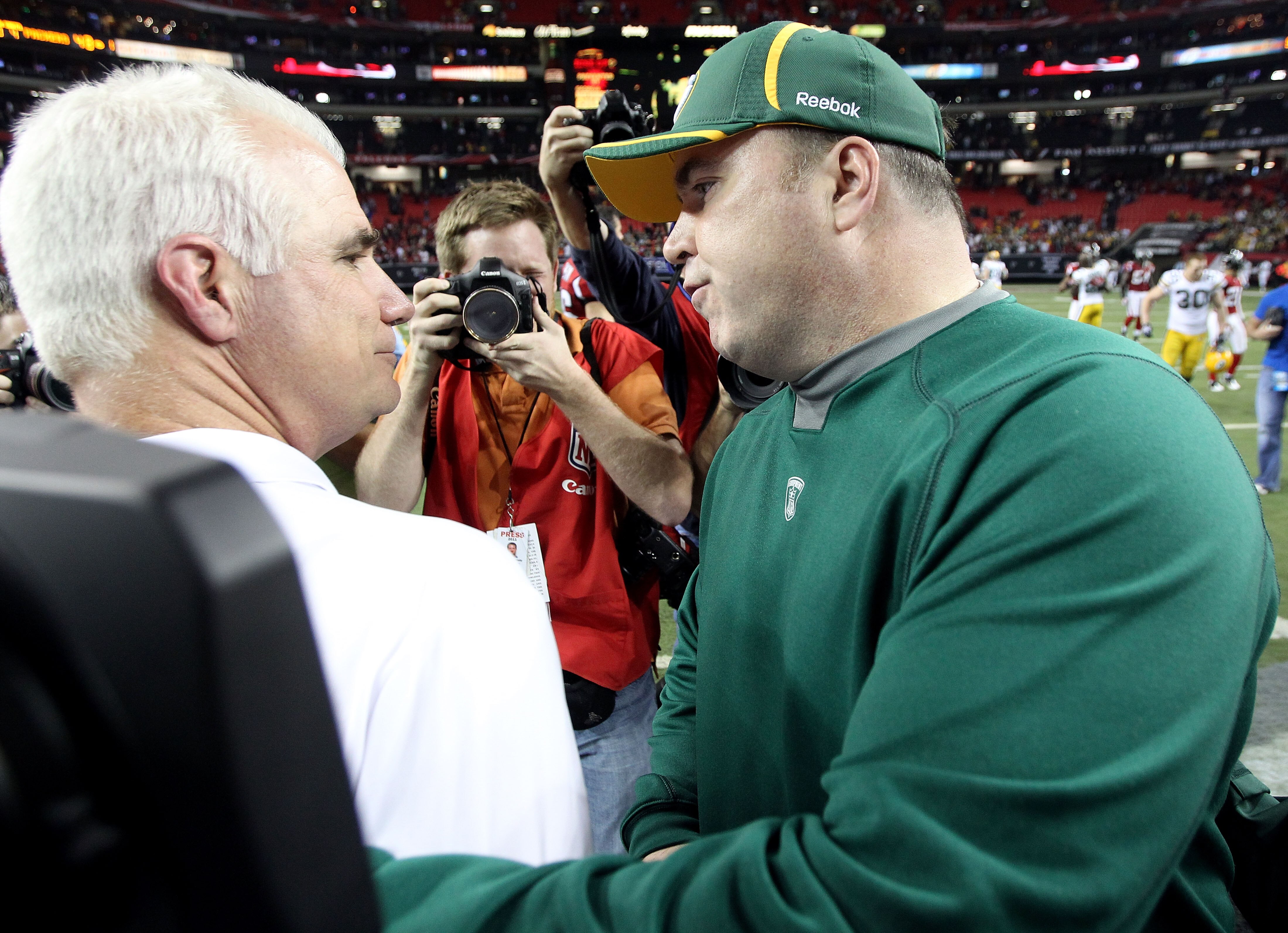 ATLANTA, GA - JANUARY 15:  Head coach Mike Smith of the Atlanta Falcons congratulates head coach Mike McCarthy of the Green Bay Packers after the Packwers won 48-21 during their 2011 NFC divisional playoff game at Georgia Dome on January 15, 2011 in Atlan