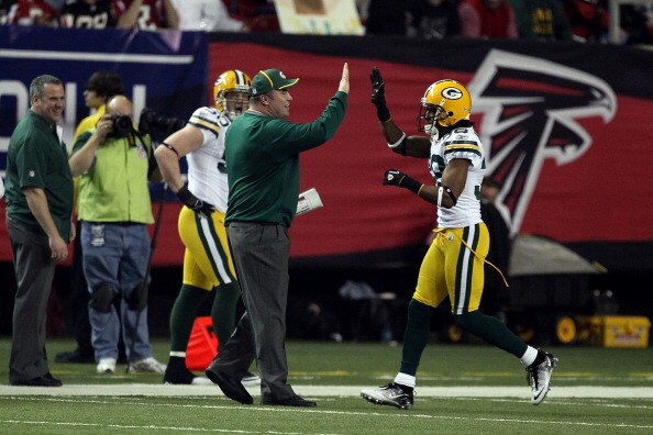 ATLANTA, GA - JANUARY 15:  Head coach Mike McCarthy of the Green Bay Packers celebraters a defensive play with Tramon Williams #38 of the Atlanta Falcons during their 2011 NFC divisional playoff game at Georgia Dome on January 15, 2011 in Atlanta, Georgia