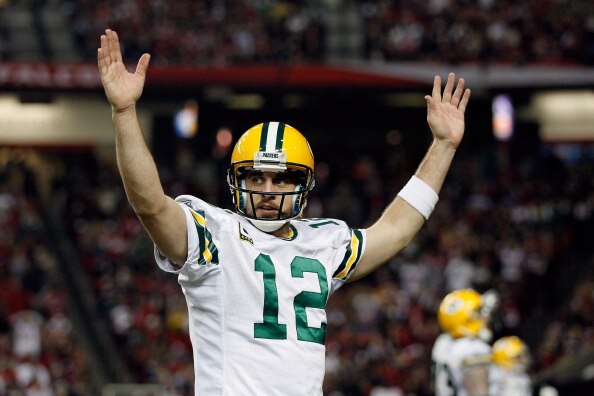 ATLANTA, GA - JANUARY 15:  Aaron Rodgers #12 of the Green Bay Packers reacts after he threw a 7-yard touchdown to John Kuhn #30 in the third quarter against the Atlanta Falcons during their 2011 NFC divisional playoff game at Georgia Dome on January 15, 2