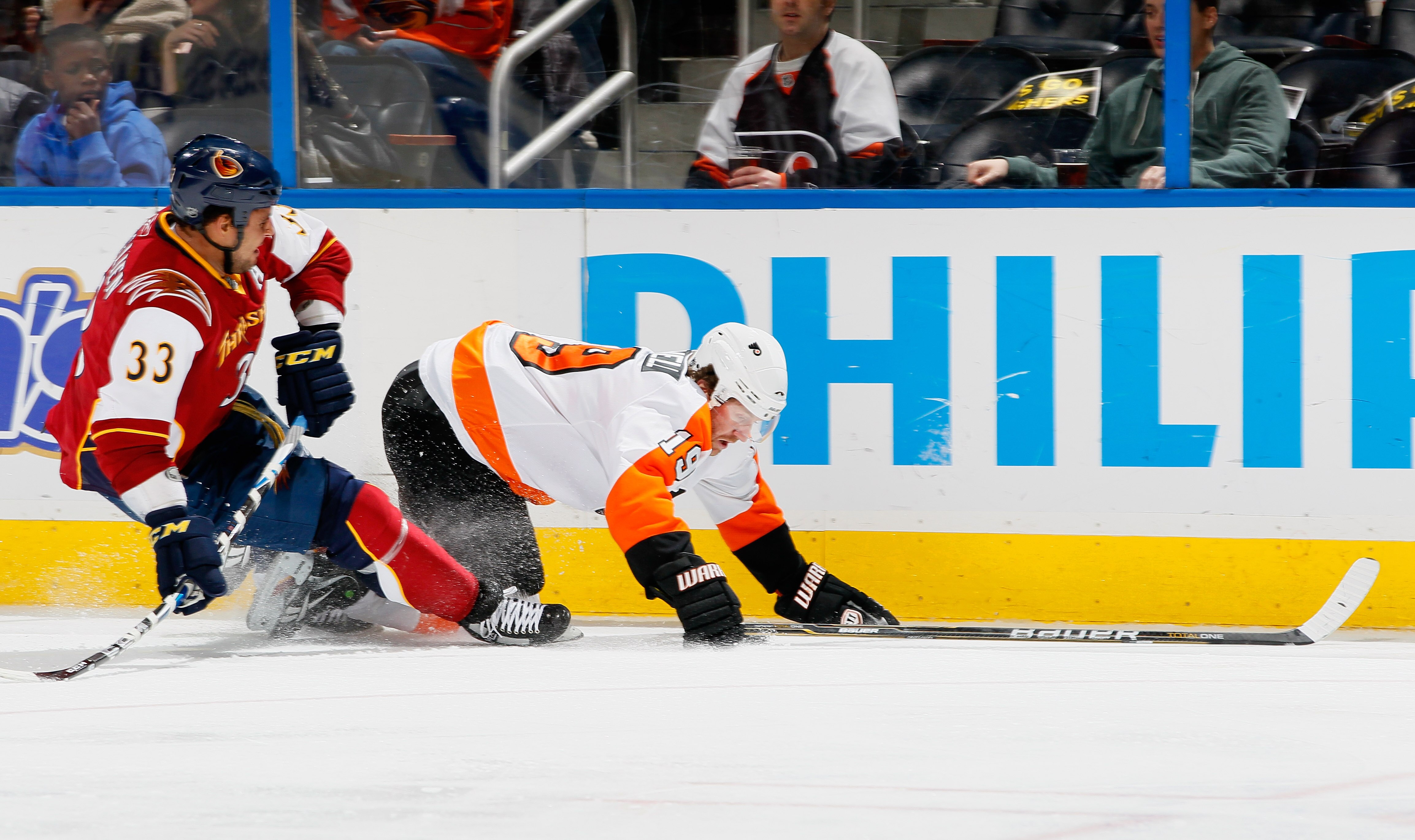 ATLANTA, GA - JANUARY 14:  Scott Hartnell #19 of the Philadelphia Flyers falls to the ice in front of Dustin Byfuglien #33 of the Atlanta Thrashers at Philips Arena on January 14, 2011 in Atlanta, Georgia.  (Photo by Kevin C. Cox/Getty Images)
