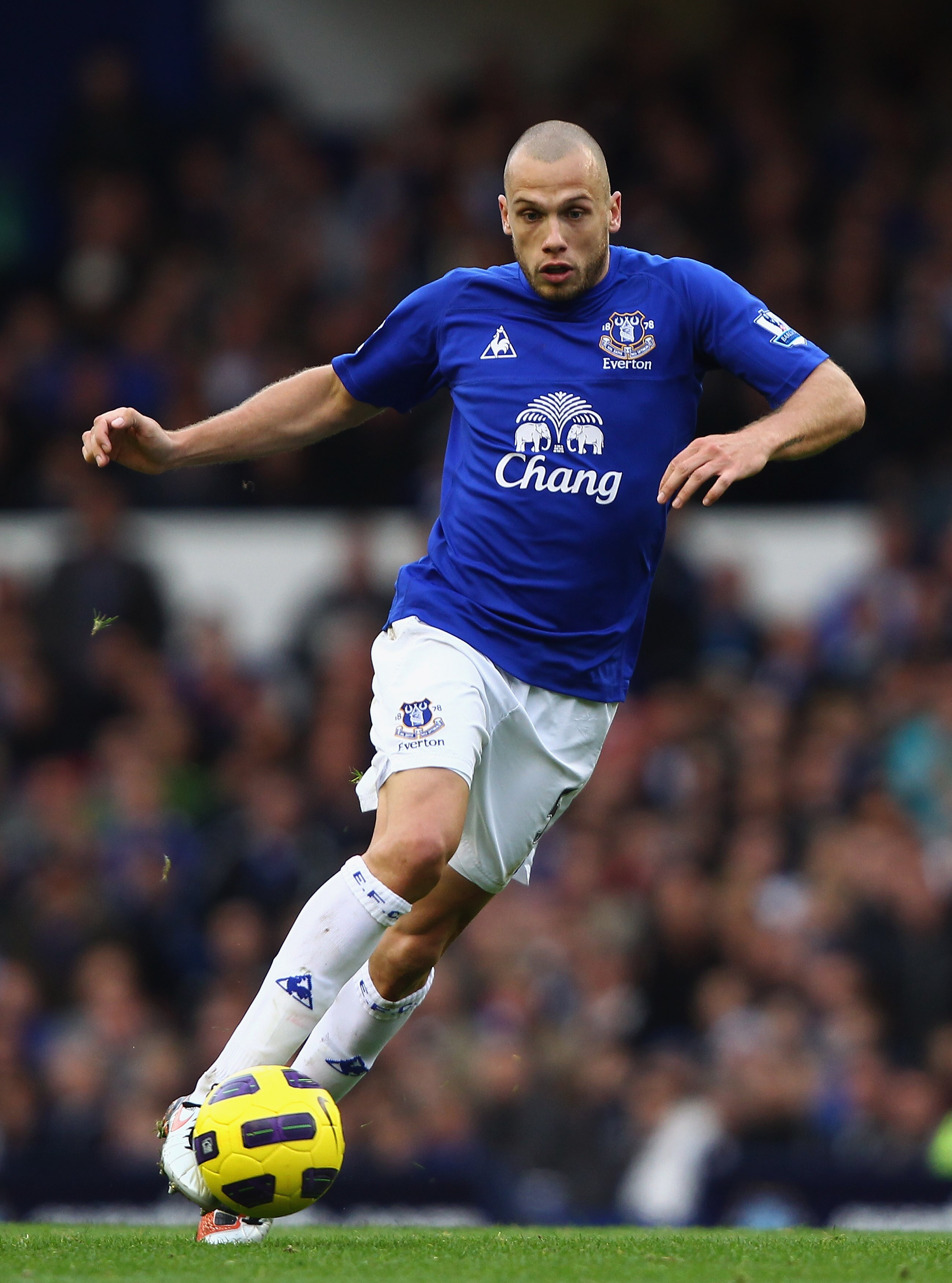LIVERPOOL, ENGLAND - OCTOBER 30: John Heitinga  of Everton holds off a challenge from of Stoke City during the Barclays Premier League match between Everton and Stoke City at Goodison Park on October 30, 2010 in Liverpool, England.  (Photo by Clive Brunsk