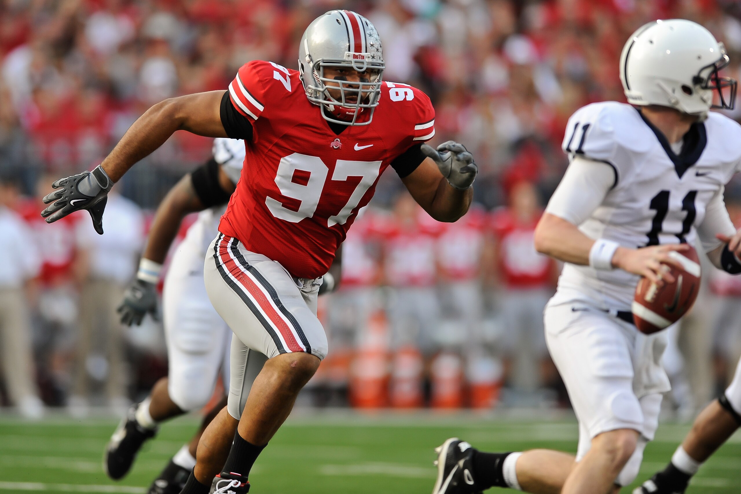 COLUMBUS, OH - NOVEMBER 13:  Cameron Heyward #97 of the Ohio State Buckeyes chases after quarterback Matt McGloin #11 of the Penn State Nittany Lions at Ohio Stadium on November 13, 2010 in Columbus, Ohio.  (Photo by Jamie Sabau/Getty Images)