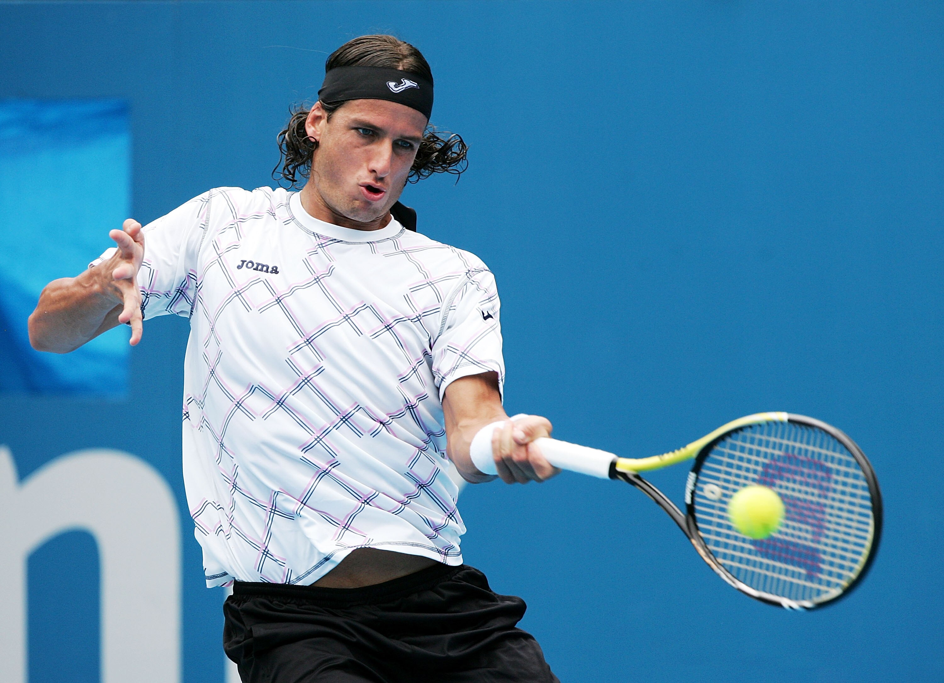 SYDNEY, AUSTRALIA - JANUARY 10:  Feliciano Lopez of Spain plays a forehand in his/her match against Juan Martin Del Potro of Argentina during day two of the 2011 Medibank International at Sydney Olympic Park Tennis Centre on January 10, 2011 in Sydney, Au