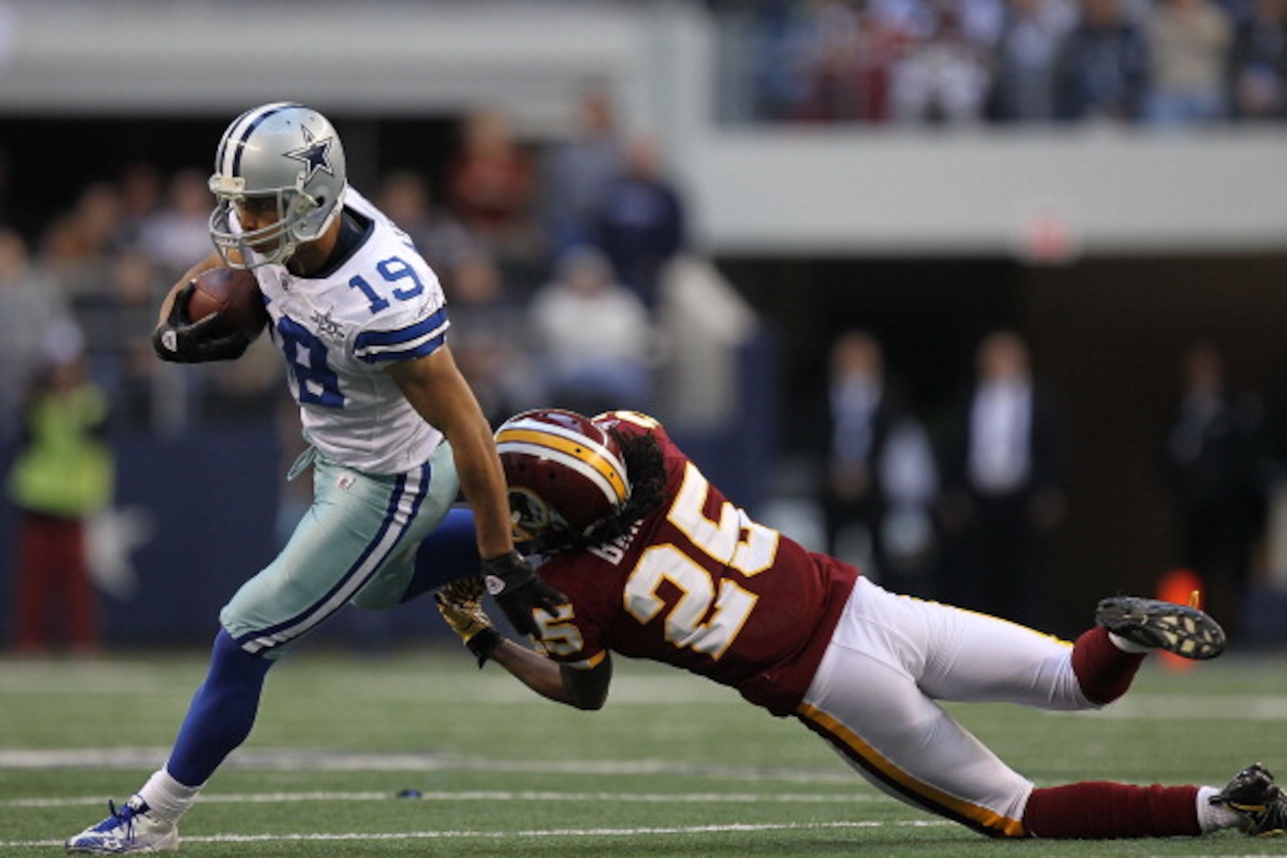 ARLINGTON, TX - DECEMBER 19:  Wide receiver Miles Austin #19 of the Dallas Cowboys runs the ball against Kevin Barnes #25 of the Washington Redskins at Cowboys Stadium on December 19, 2010 in Arlington, Texas.  (Photo by Ronald Martinez/Getty Images)