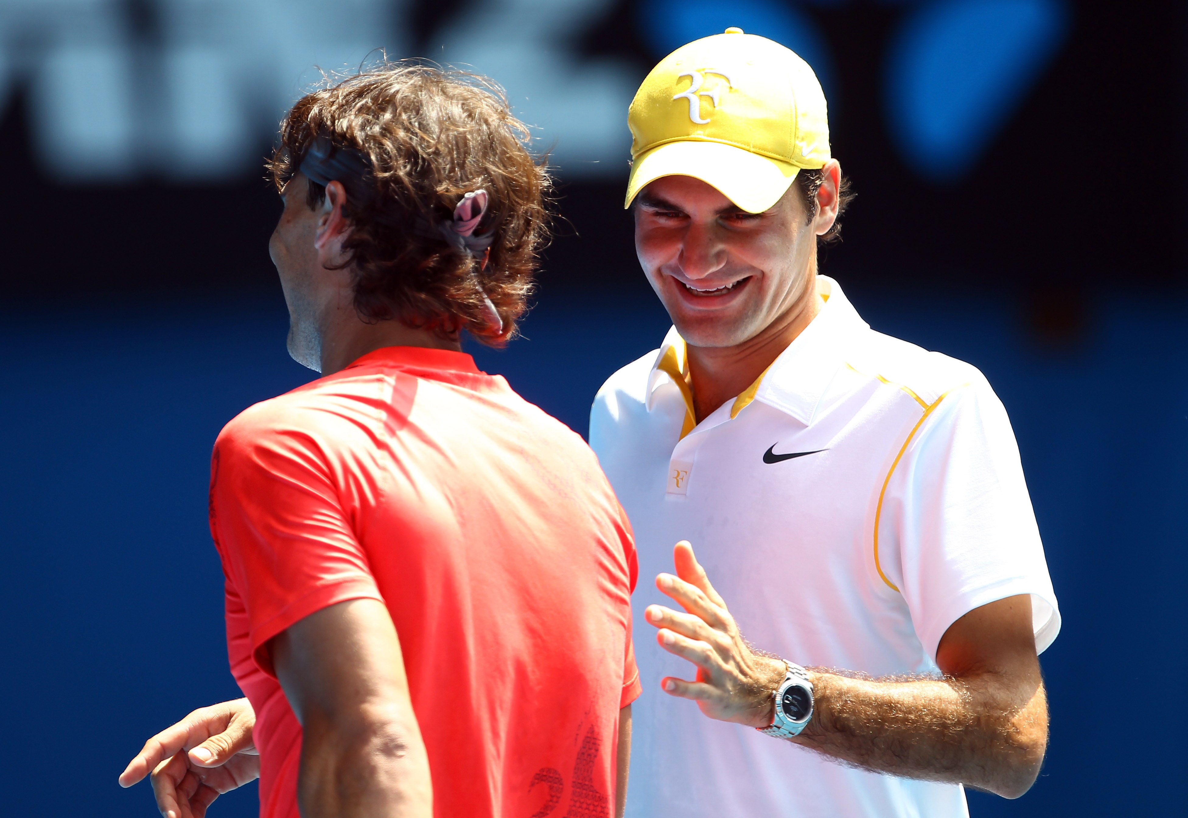 MELBOURNE, AUSTRALIA - JANUARY 16:  Rafael Nadal of Spain and Roger Federer enjoy the day during the 'Rally For Relief' charity exhibition match ahead of the 2011 Australian Open at Melbourne Park on January 16, 2011 in Melbourne, Australia.  (Photo by Ju
