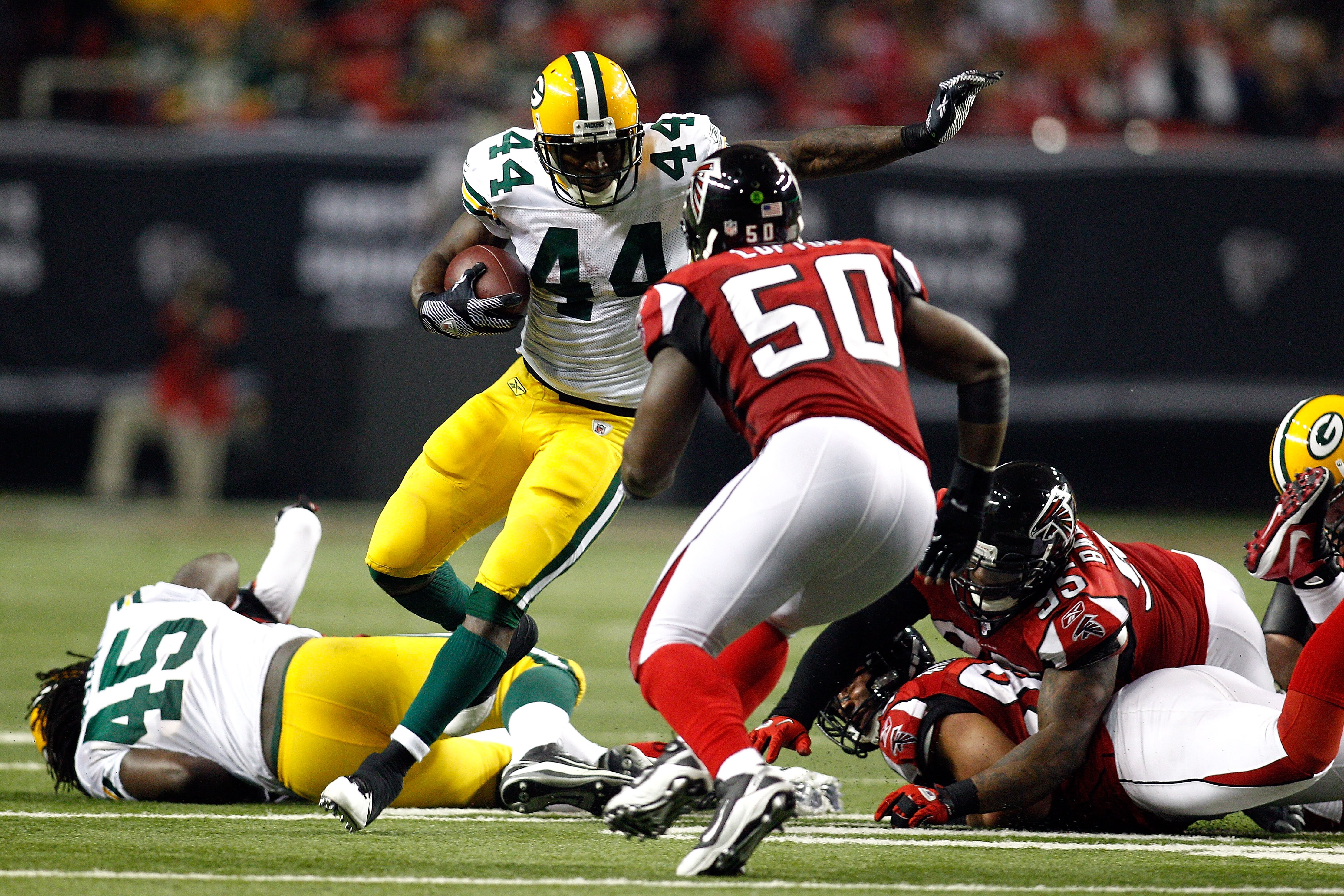 ATLANTA, GA - JANUARY 15:  James Starks #44 of the Green Bay Packers runs the ball against Curtis Lofton #50 of the Atlanta Falcons during their 2011 NFC divisional playoff game at Georgia Dome on January 15, 2011 in Atlanta, Georgia.  (Photo by Chris Gra