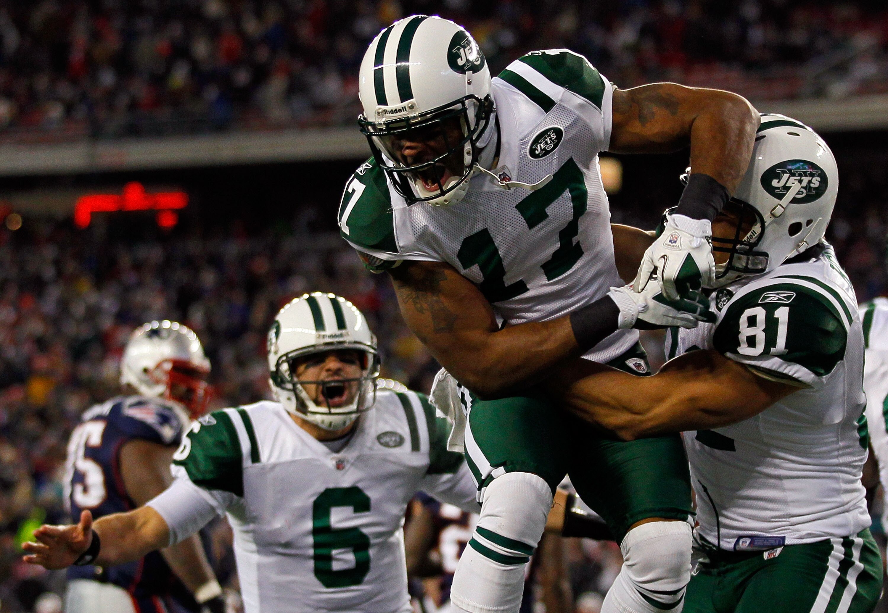 FOXBORO, MA - JANUARY 16:  Braylon Edwards #17 celebrates with Dustin Keller #81 and Mark Sanchez #6 of the New York Jets after Edwards scored a second quarter touchdown during their 2011 AFC divisional playoff game against the New England Patriots at Gil