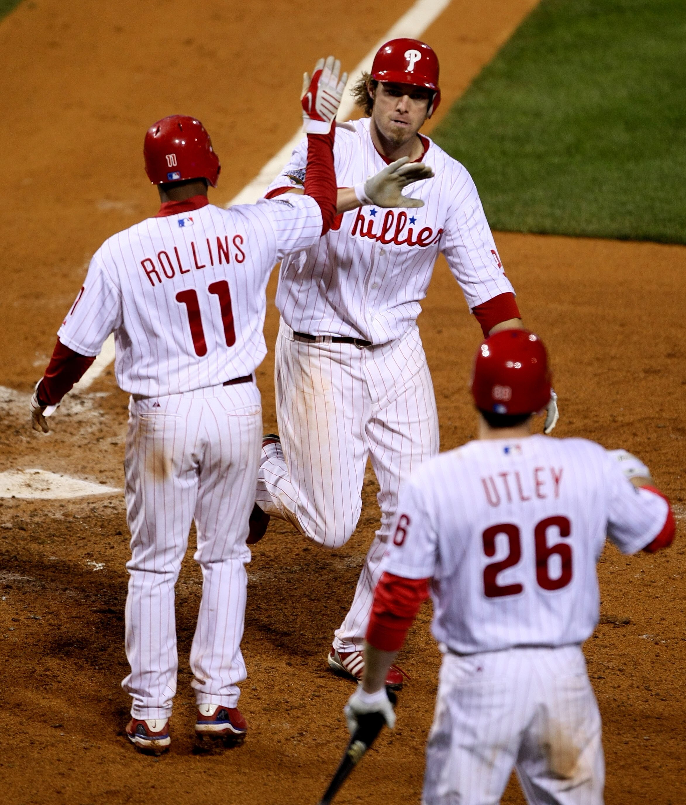 PHILADELPHIA - OCTOBER 26:  Jayson Werth #28 of the Philadelphia Phillies celebrates with Jimmy Rollins #11 and Chase Utley #26 after hitting a two-run home run against the Tampa Bay Rays during game four of the 2008 MLB World Series on October 26, 2008 a