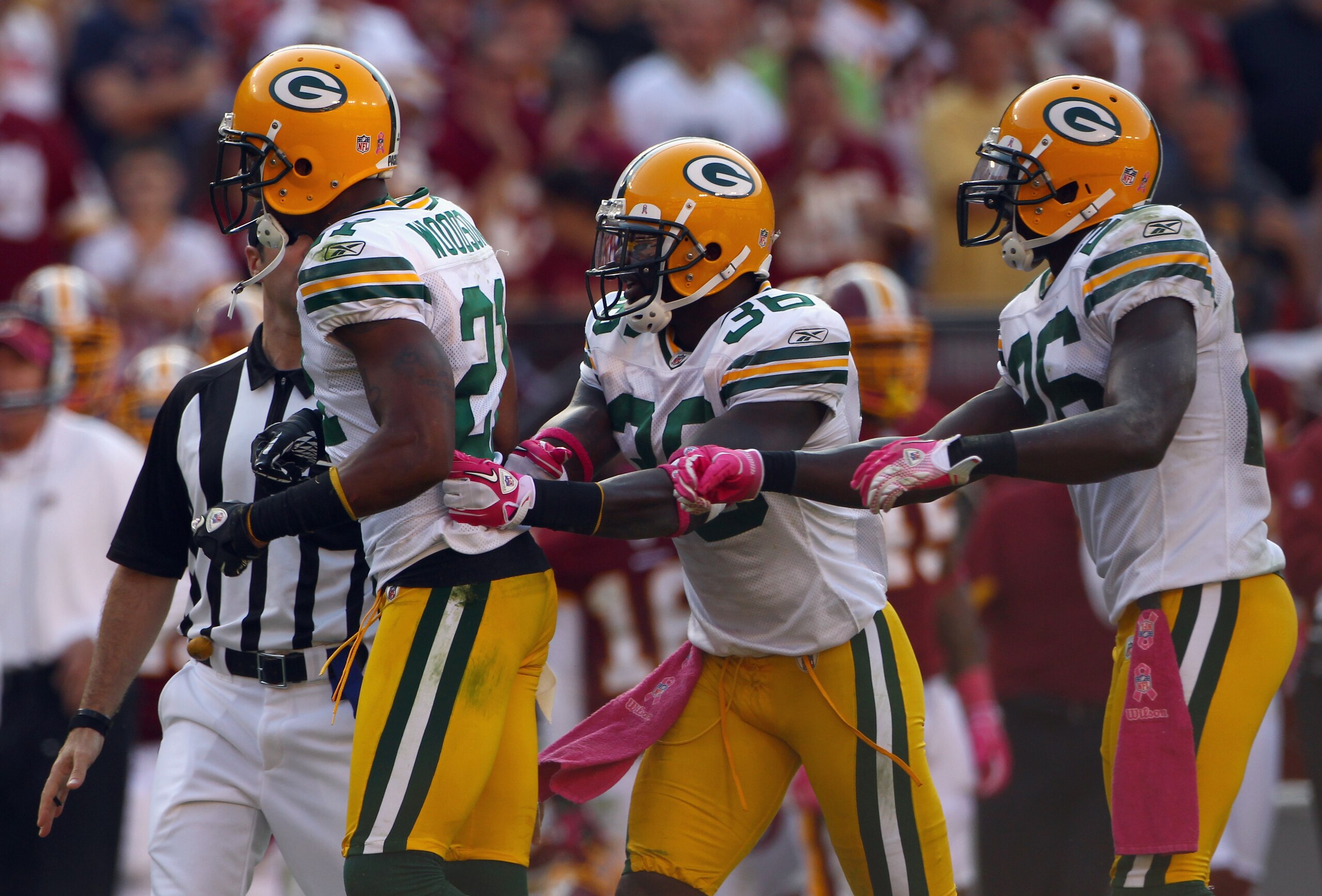 LANDOVER, MD - OCTOBER 10:  Defensive back Charles Woodson #21 of the Green Bay Packers is restrained by teammates Nick Collins #36 and Josh Bell #26 while arguing an official's call in the fourth quarter against the Washington Redskins at FedExField on O