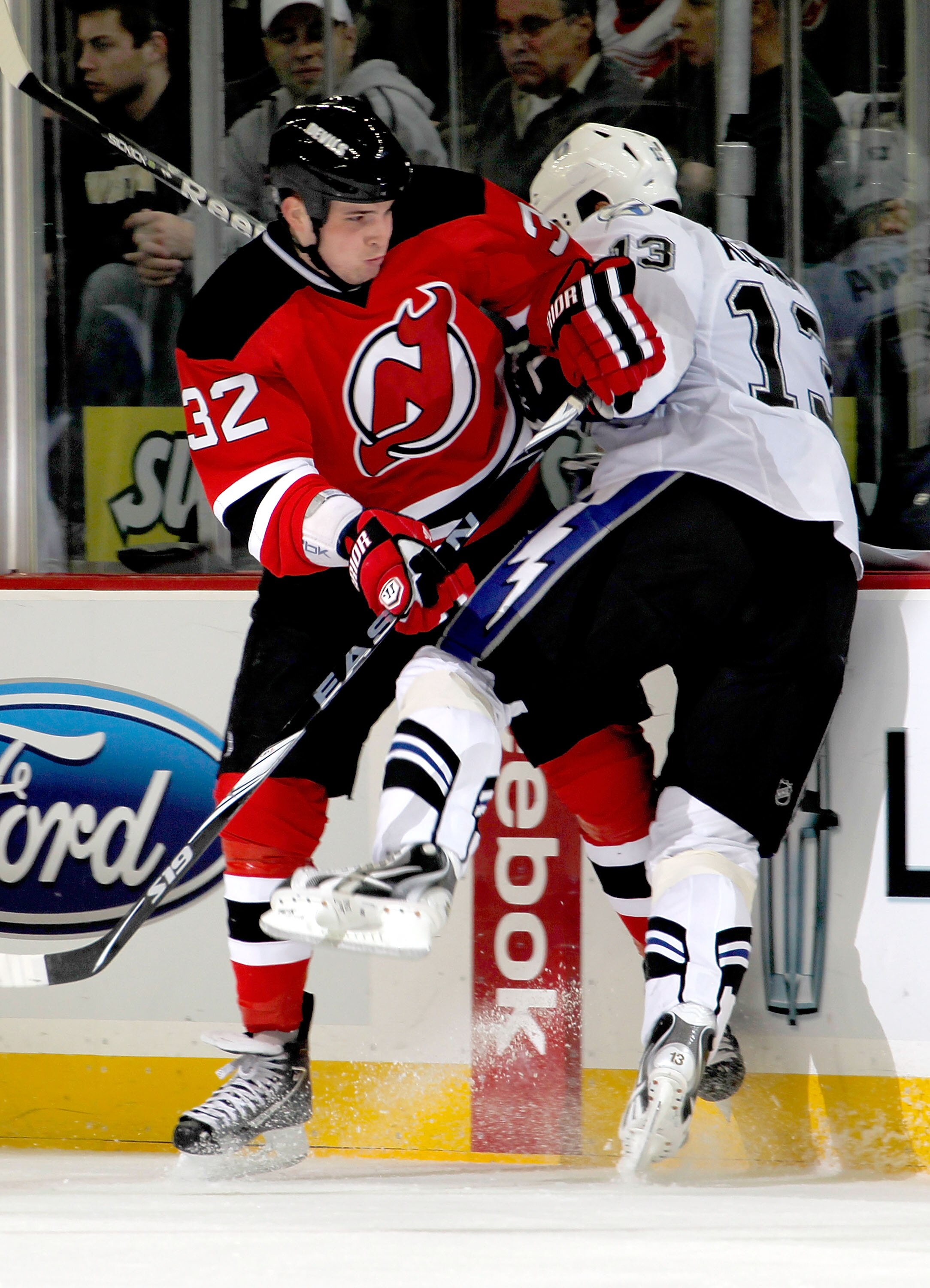 NEWARK, NJ - JANUARY 09:  Nick Palmieri #32 of the New Jersey Devils throws a check during an NHL hockey game against the Tampa Bay Lightning at the Prudential Center on January 9, 2011 in Newark, New Jersey.  (Photo by Paul Bereswill/Getty Images)