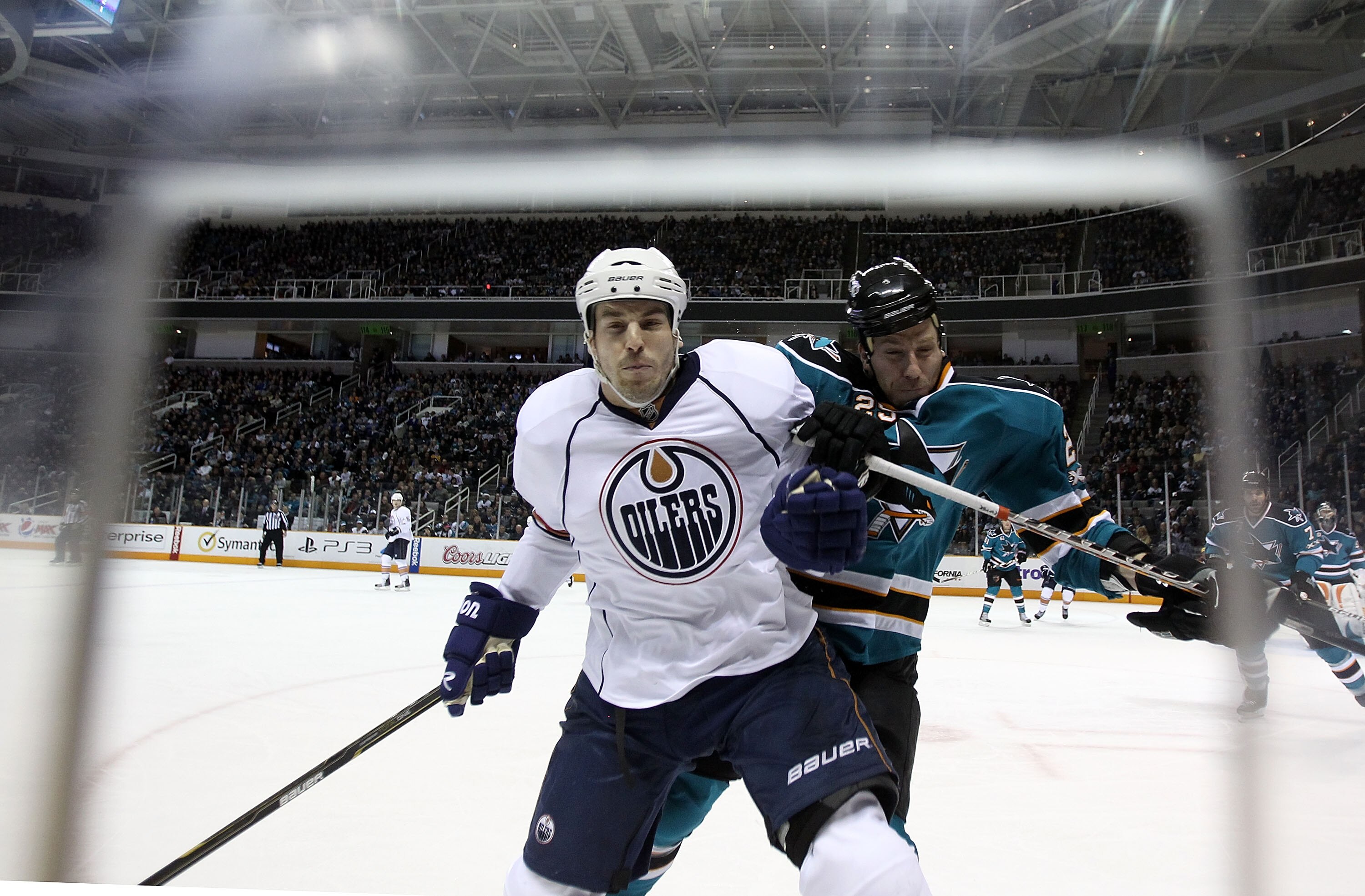 SAN JOSE, CA - DECEMBER 21:  Jean-Francois Jacques #22 of the Edmonton Oilers is hit by Ryane Clowe #29 of the San Jose Sharks at HP Pavilion on December 21, 2010 in San Jose, California.  (Photo by Ezra Shaw/Getty Images)