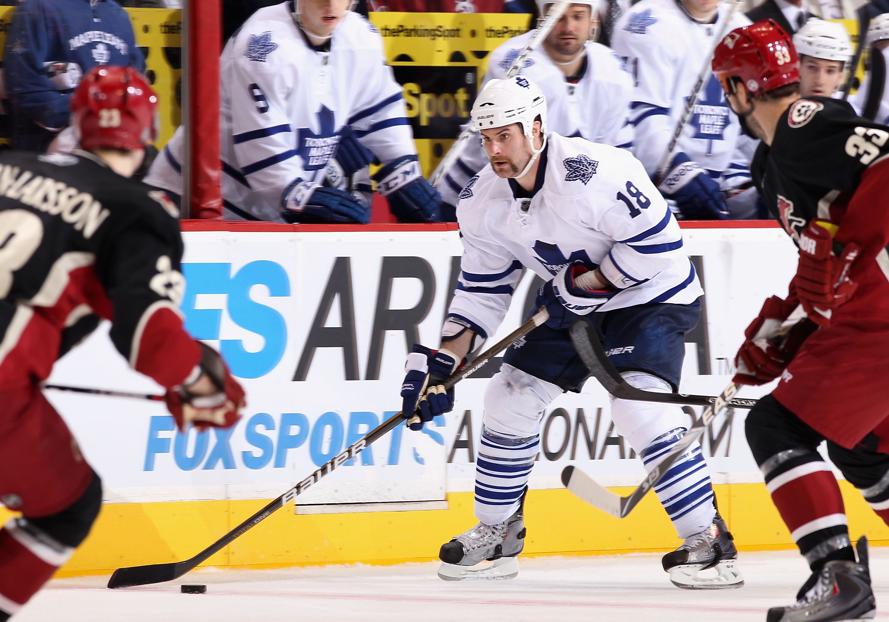 GLENDALE, AZ - JANUARY 13:  Mike Brown #18 of the Toronto Maple Leafs skates with the puck during the NHL game against the Phoenix Coyotes at Jobing.com Arena on January 13, 2011 in Glendale, Arizona. The Coyotes defeated the Maple Leafs 5-1.  (Photo by C
