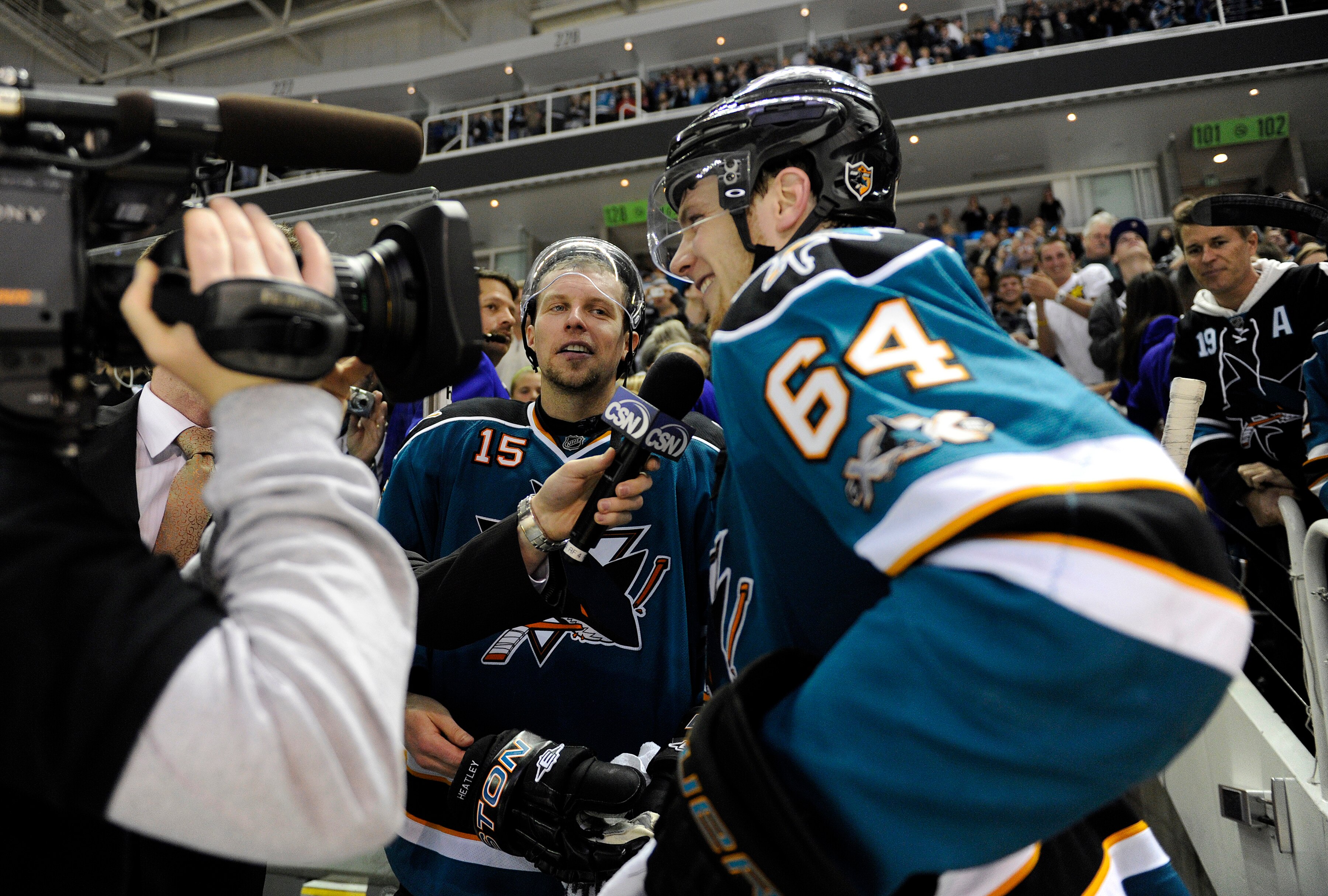 SAN JOSE, CA - JANUARY 15: Stars of the game Dany Heatley #15 and Jamie McGinn #64 of the San Jose Sharks are being interviewed after they defeated the St. Louis Blues 4-2 in an NHL hockey game at the HP Pavilion on January 15, 2011 in San Jose, Californi