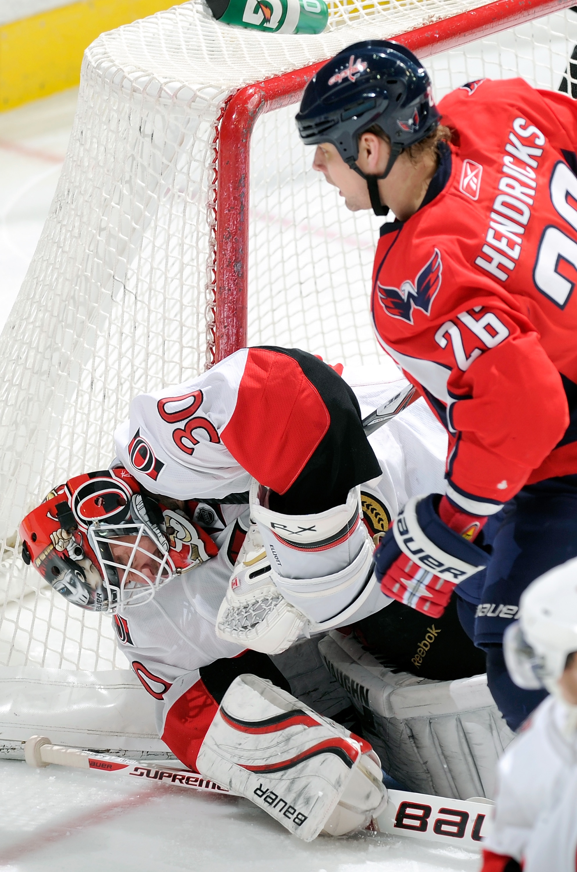 WASHINGTON, DC - JANUARY 16:  Matt Hendricks #26 of the Washington Capitals gets his stick caught in the mask of Brian Elliott #30 of the Ottawa Senators at the Verizon Center on January 16, 2011 in Washington, DC.  (Photo by Greg Fiume/Getty Images)
