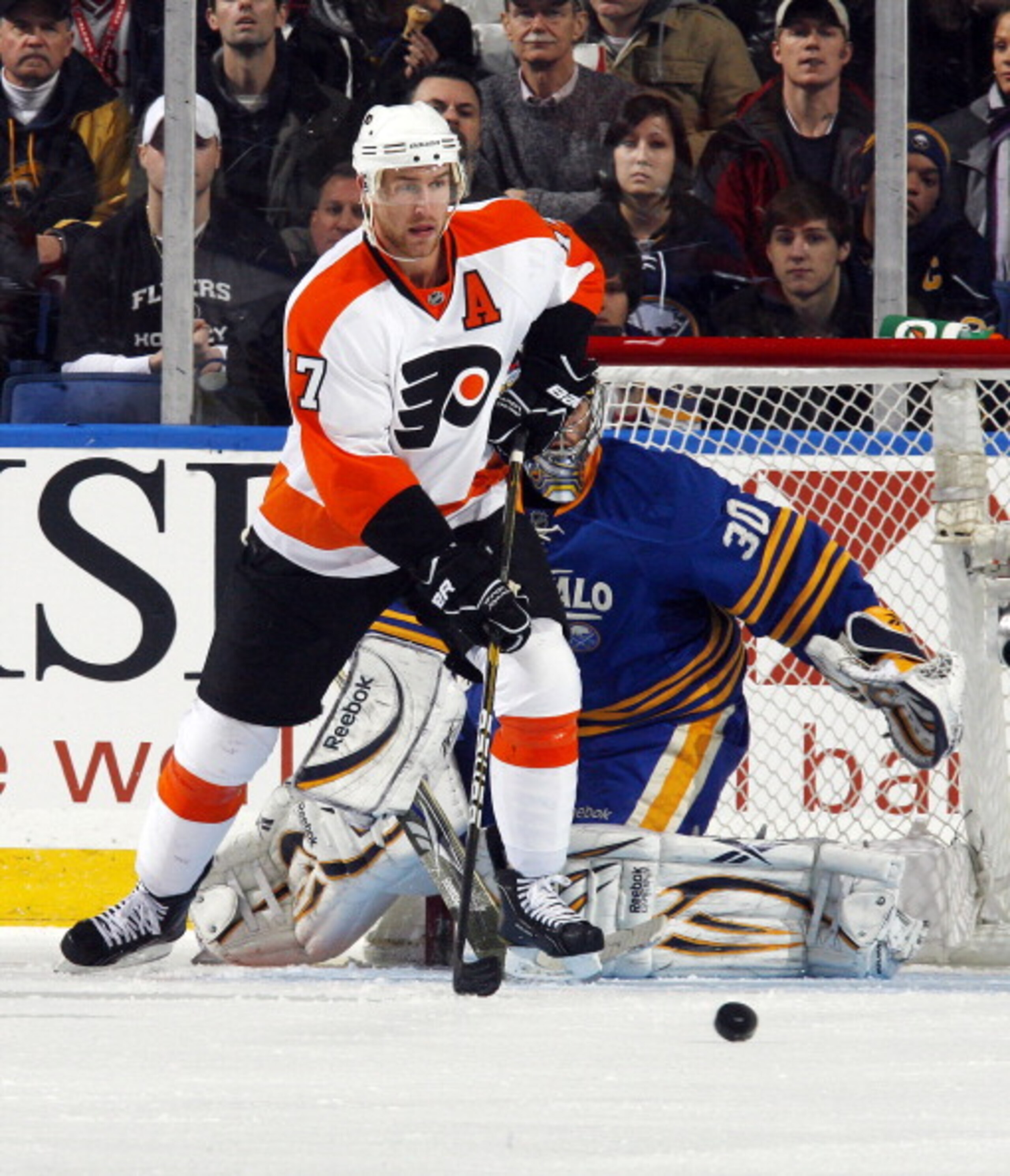 BUFFALO NY - JANUARY 11:  Jeff Carter #17 of the Philadelphia Flyers keeps his eye on the puck after Ryan Miller #30 of the Buffalo Sabres makes a save during their NHL game at HSBC Arena January 11, 2011 in Buffalo, New York. (Photo By Dave Sandford/Gett