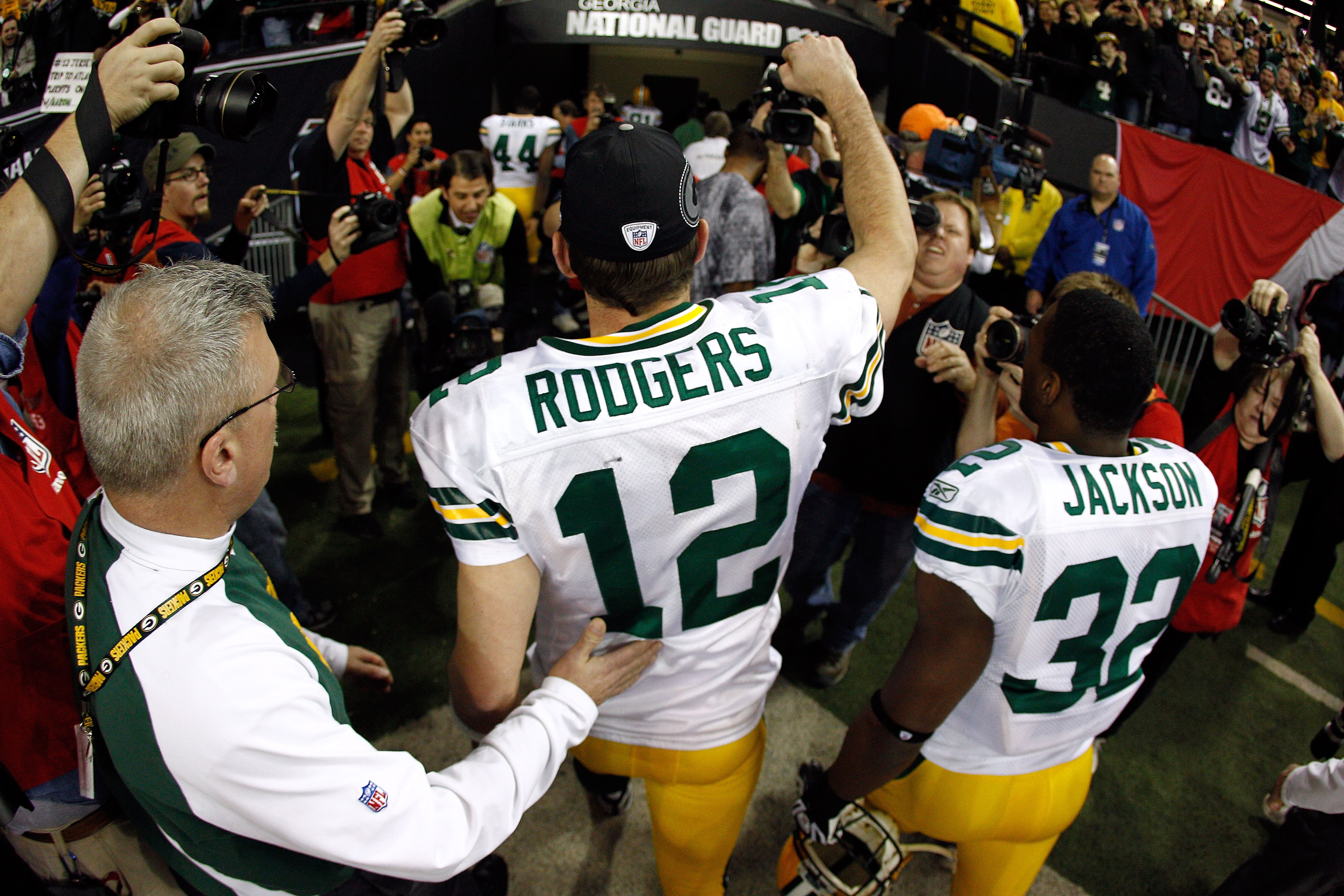 ATLANTA, GA - JANUARY 15:  Aaron Rodgers #12 and Brandon Jackson #32 of the Green Bay Packers celebrate as they walk off the field after the Packers won 48-21 against the Atlanta Falcons during their 2011 NFC divisional playoff game at Georgia Dome on Jan