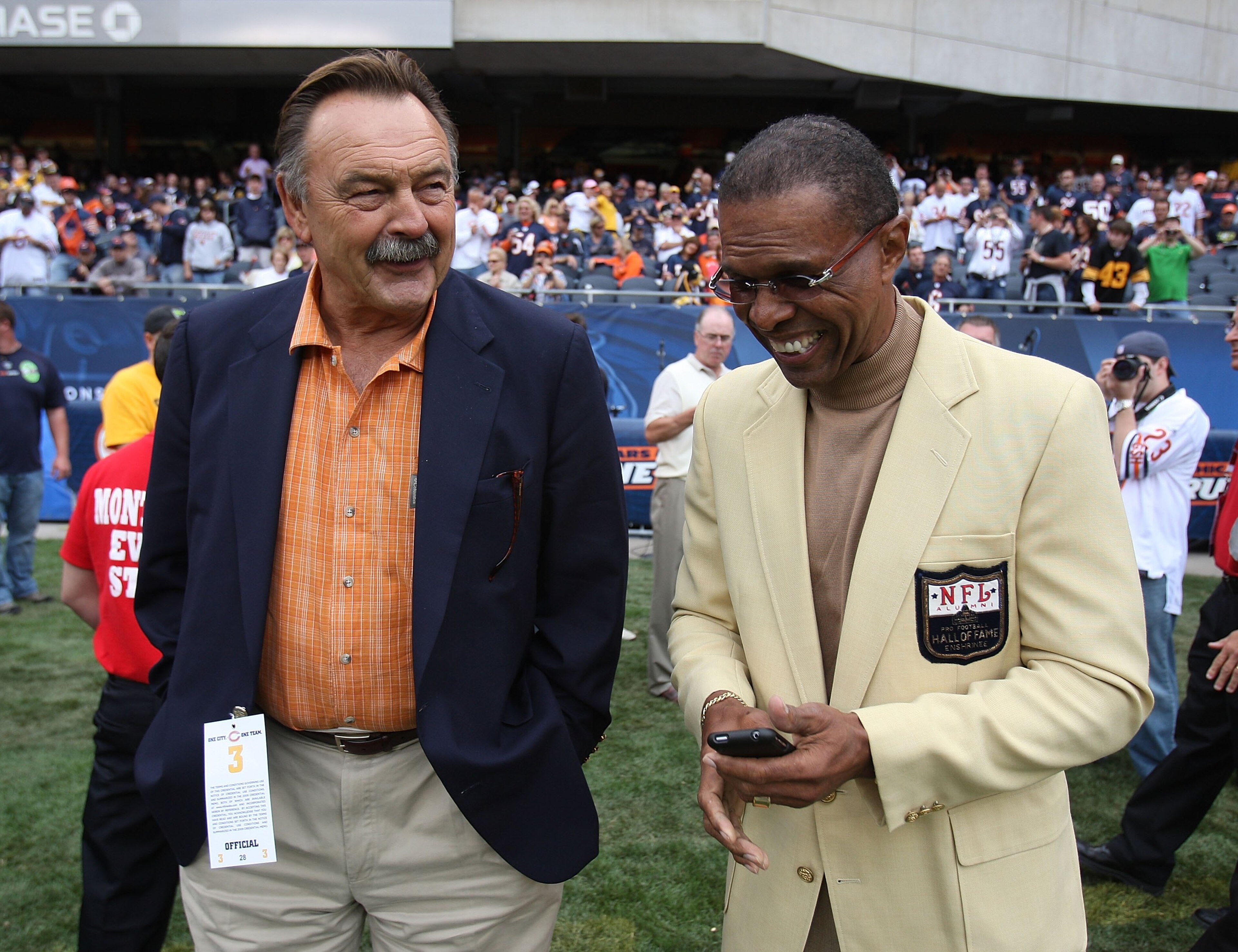 CHICAGO - SEPTEMBER 20: Hall of Fame Chicago Bears Dick Butkus (L) and Gale Sayers share a laugh on the sidelines before a game between the Bears and the Pittsburgh Steelers on September 20, 2009 at Soldier Field in Chicago, Illinois. The Bears defeated t
