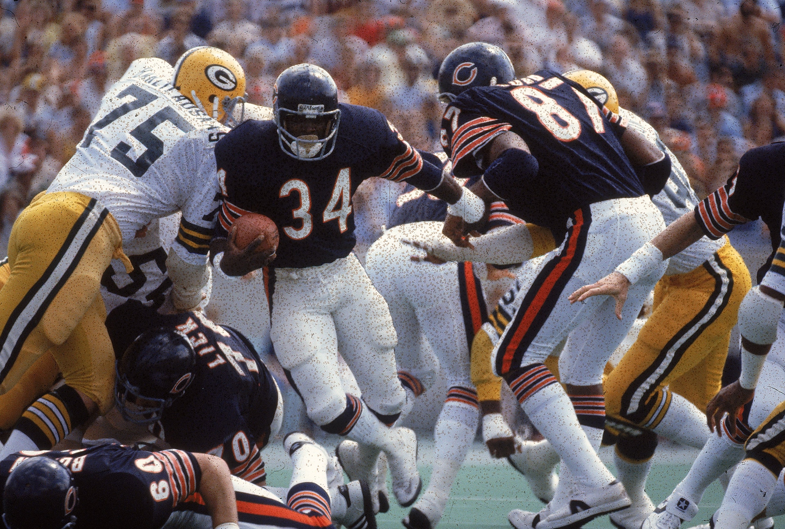 Walter Payton #34 of the Chicago Bears carries the ball during a game against the Green Bay Packers.