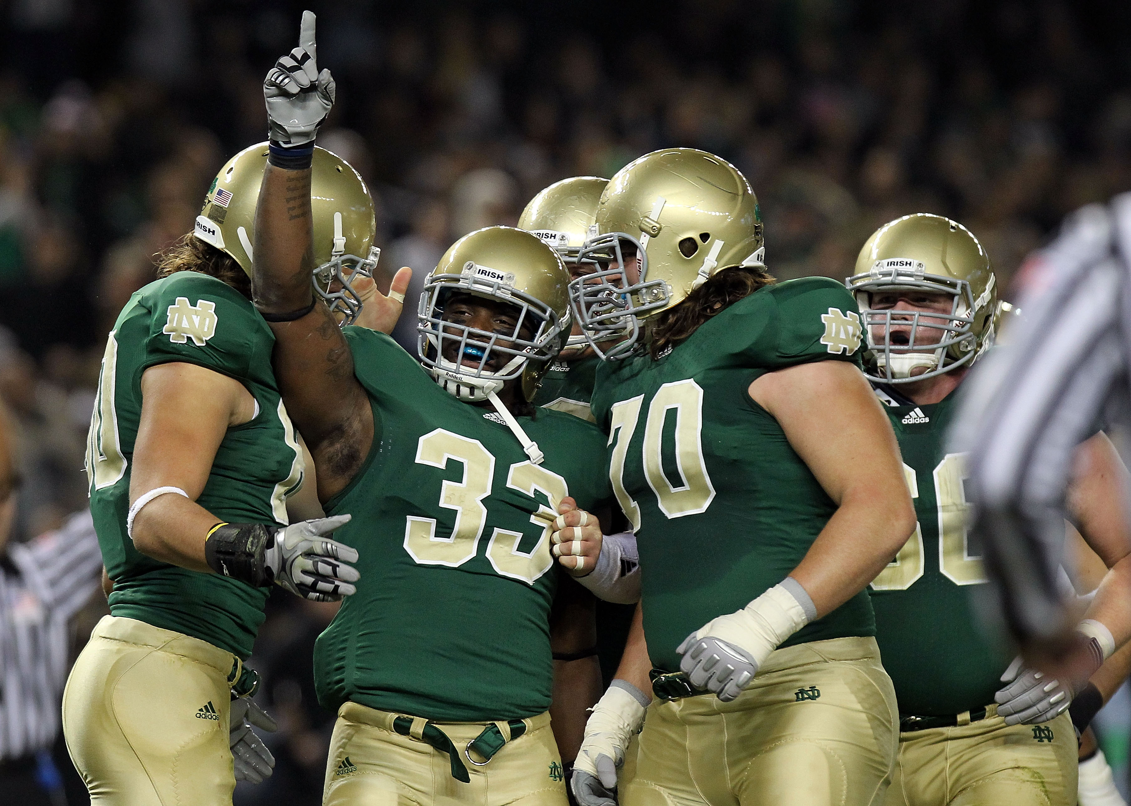 NEW YORK - NOVEMBER 20: Robert Hughes #33 of the Notre Dame Fighting Irish celebrates his touchdown with teammates agianst the Army Black Knights at Yankee Stadium on November 20, 2010 in the Bronx borough of New York City.  (Photo by Nick Laham/Getty Ima
