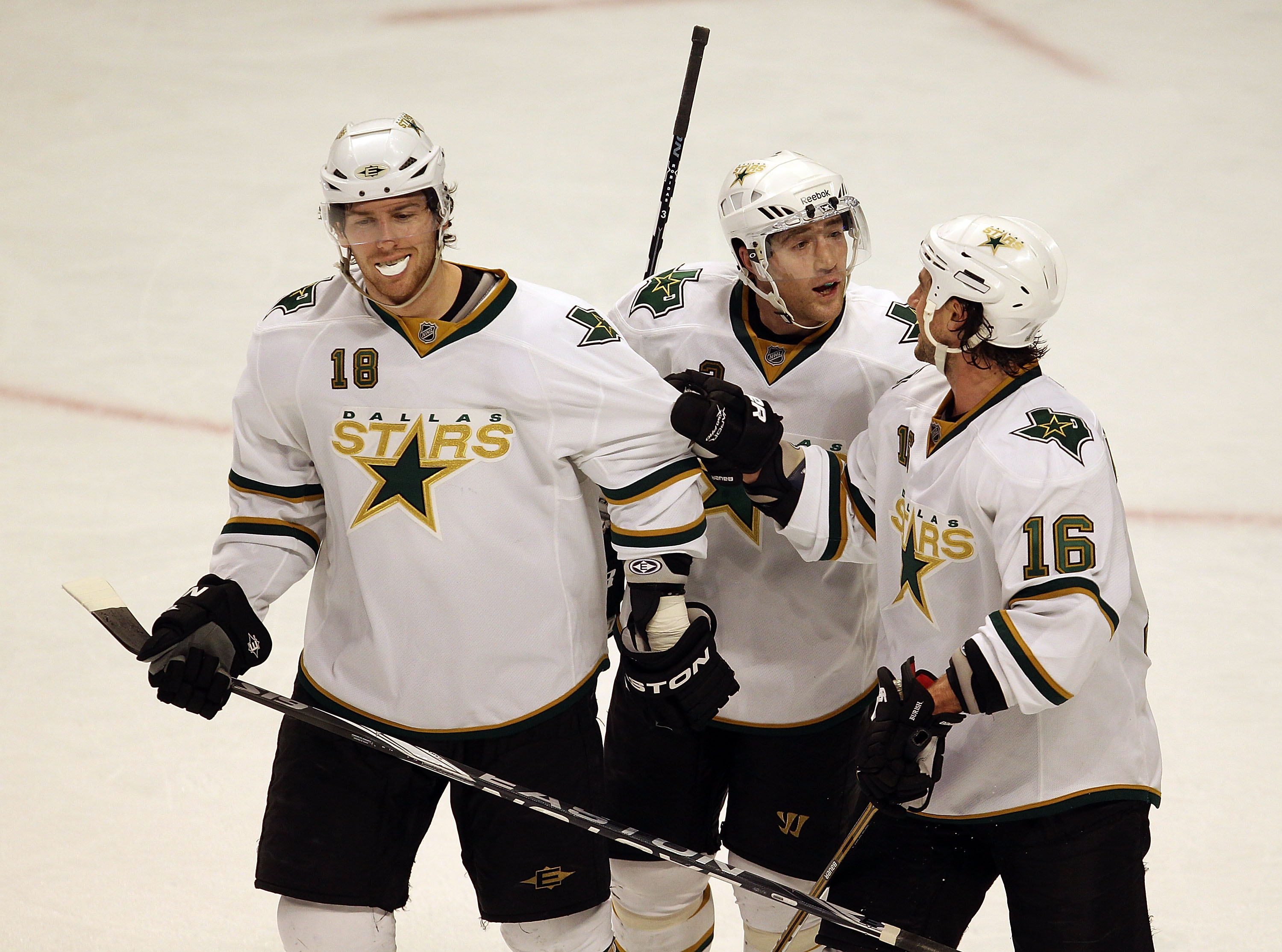 CHICAGO, IL - JANUARY 05: (L-R) James Neal #18, Stephane Robidas #3 and Adam Burish #16 of the Dallas Stars celebrate as they leave the ice after a win over the Chicago Blackhawks at the United Center on January 5, 2011 in Chicago, Illinois. The Stars def