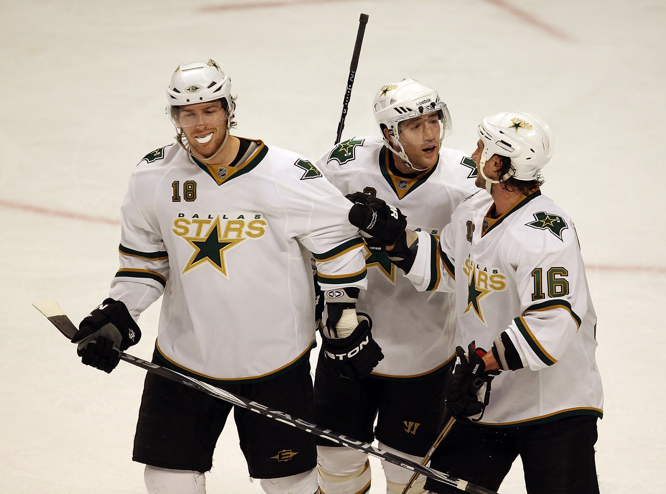 CHICAGO, IL - JANUARY 05: (L-R) James Neal #18, Stephane Robidas #3 and Adam Burish #16 of the Dallas Stars celebrate as they leave the ice after a win over the Chicago Blackhawks at the United Center on January 5, 2011 in Chicago, Illinois. The Stars def