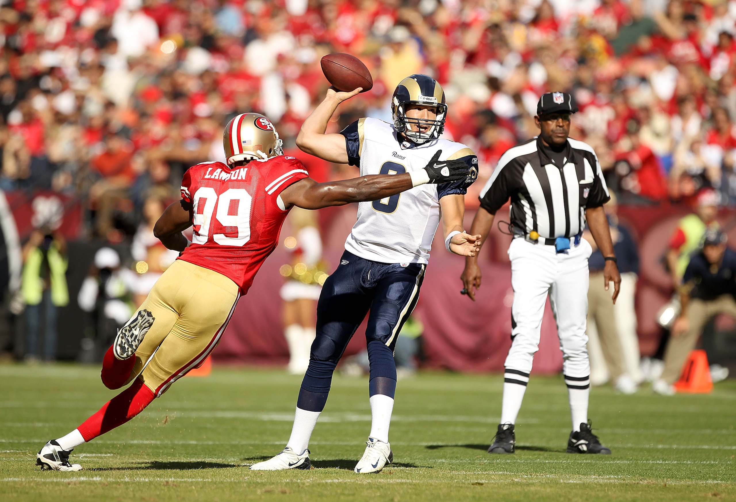 SAN FRANCISCO - NOVEMBER 14:  Sam Bradford #8  of the St. Louis Rams is hit by Manny Lawson #99 of the San Francisco 49ers at Candlestick Park on November 14, 2010 in San Francisco, California.  (Photo by Ezra Shaw/Getty Images)