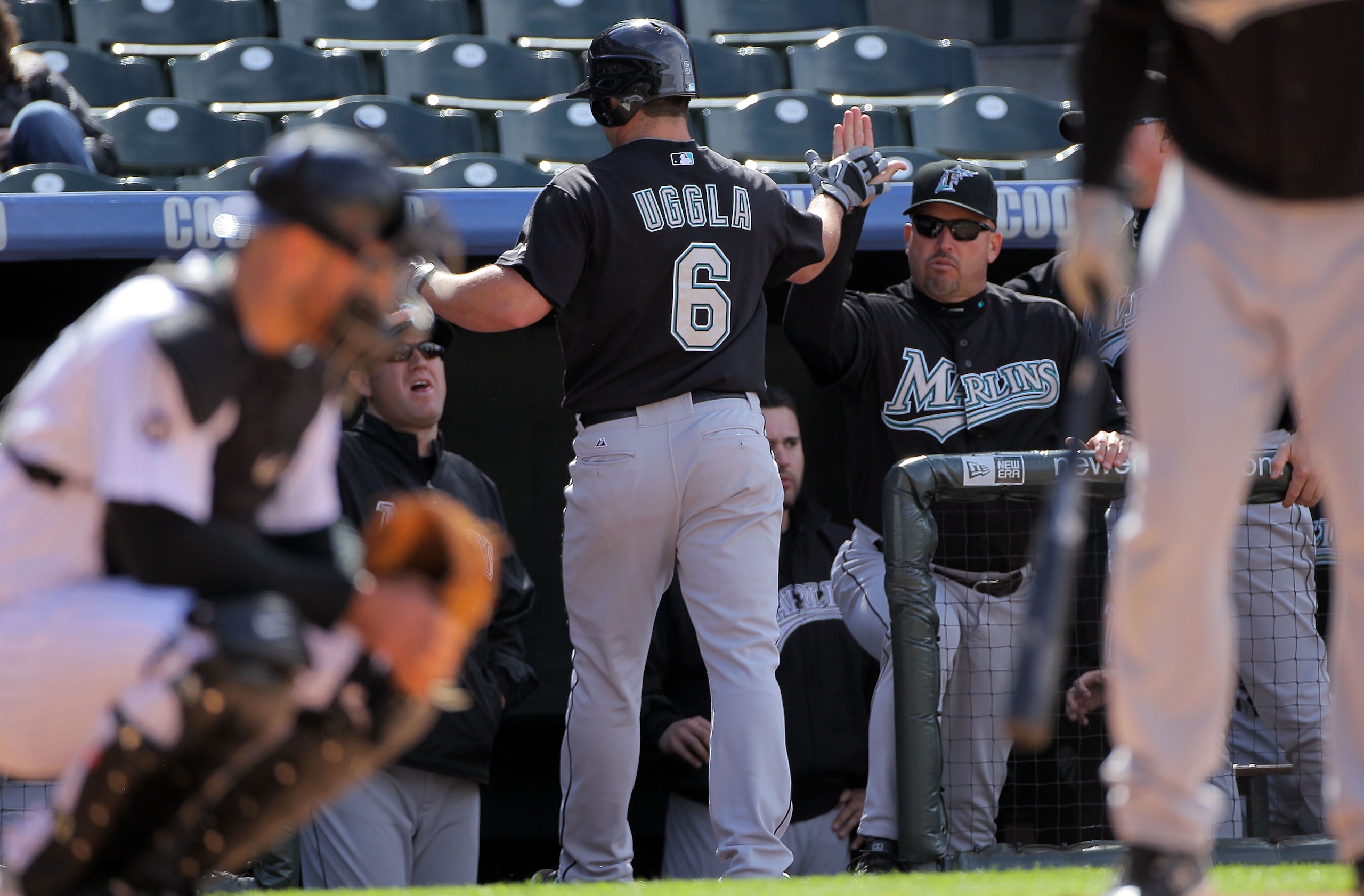 DENVER - APRIL 24:  Dan Uggla #6 of the Florida Marlins is welcomed back to the dugout by manager Fredi Gonzalez (R) #44 after his second inning solo homerun against the Colorado Rockies at Coors Field on April 24, 2010 in Denver, Colorado.  (Photo by Dou