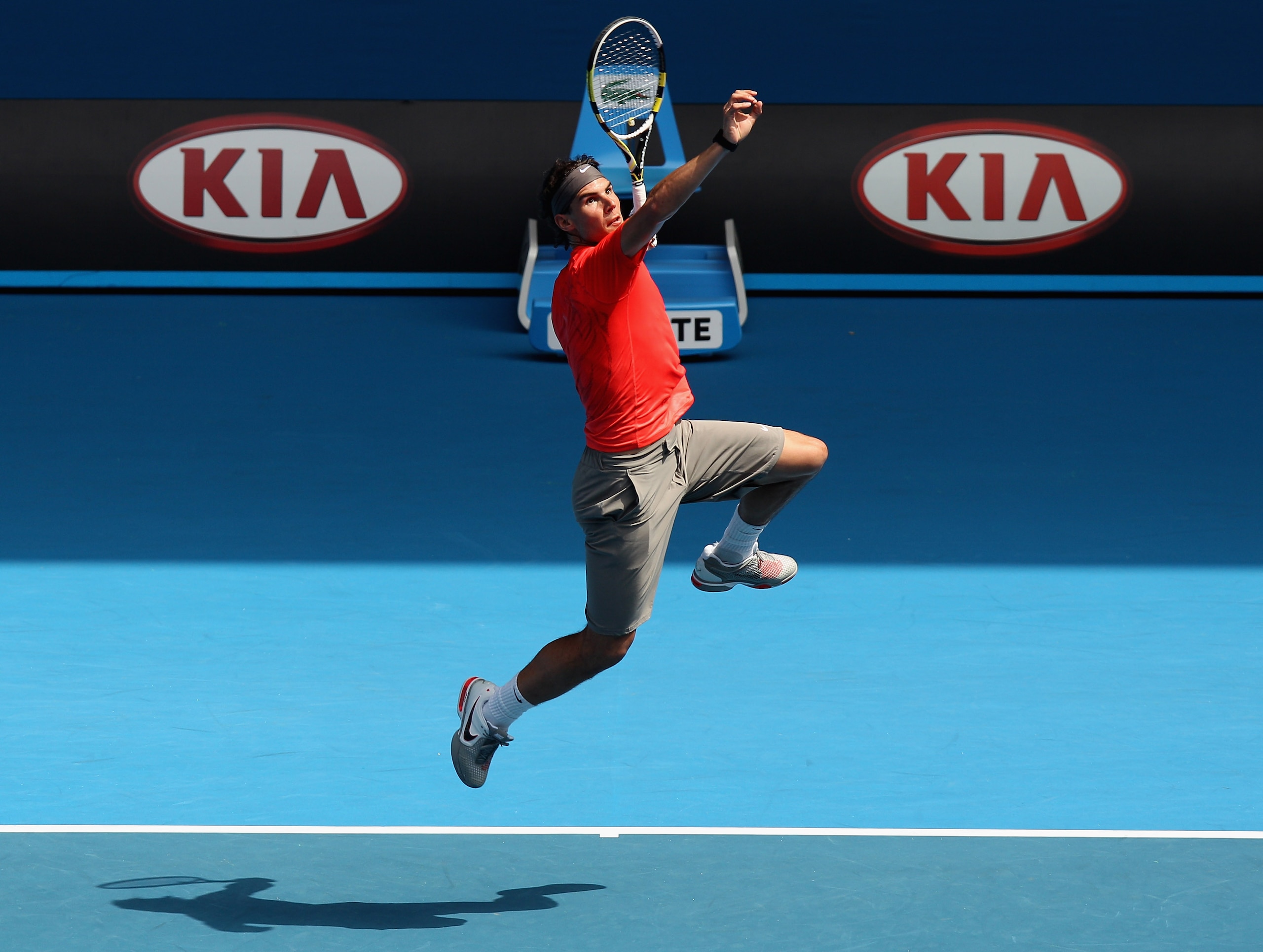MELBOURNE, AUSTRALIA - JANUARY 16:  Rafael Nadal of Spain leaps for a smash during the 'Rally For Relief' charity exhibition match ahead of the 2011 Australian Open at Melbourne Park on January 16, 2011 in Melbourne, Australia.  (Photo by Mark Dadswell/Ge