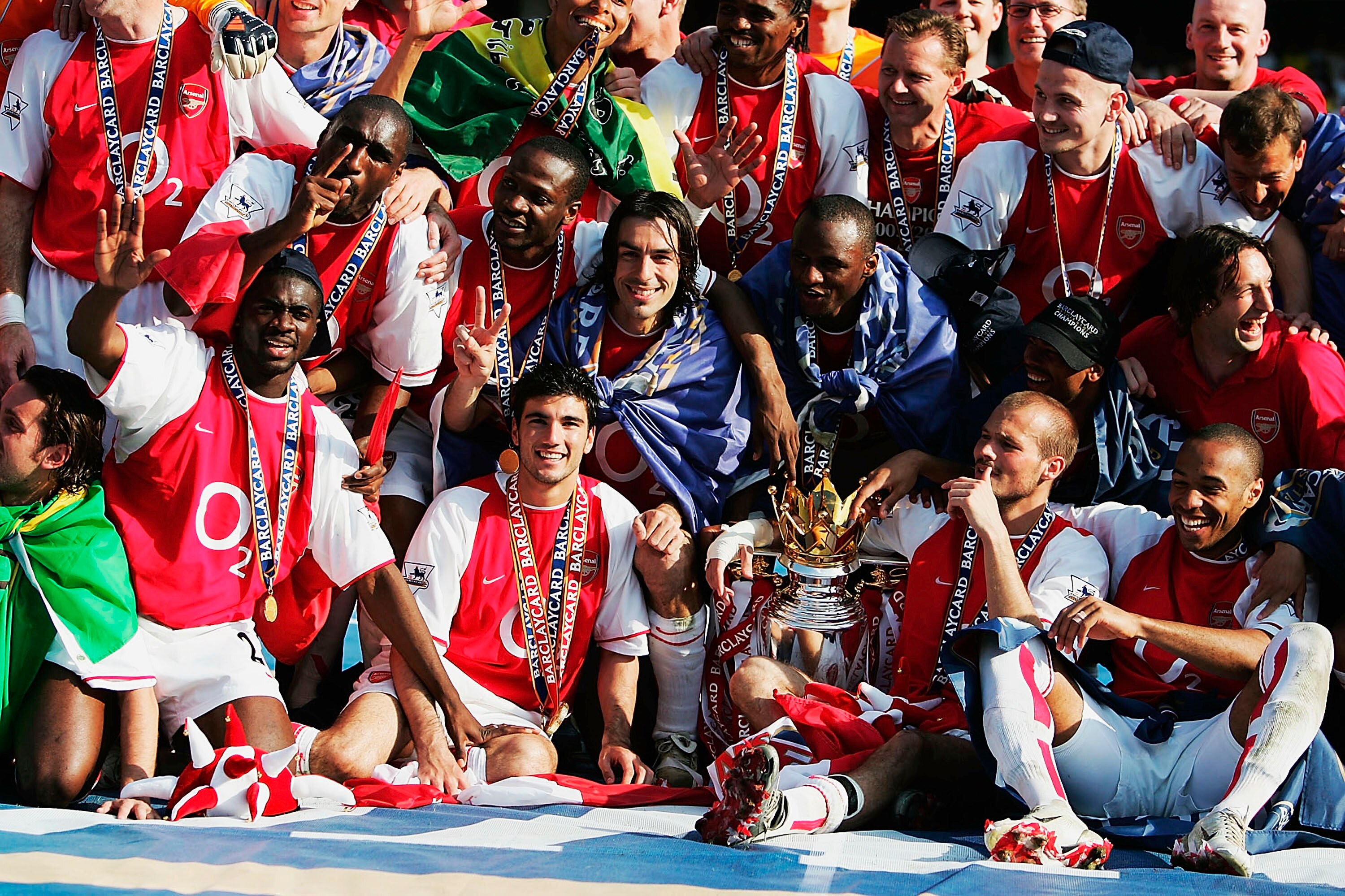 LONDON - MAY 15:  Arsenal players celebrate winning the Premiership during the FA Barclaycard Premiership match between Arsenal and Leicester City at Highbury on May 15, 2004 in London.  (Photo by Clive Mason/Getty Images)