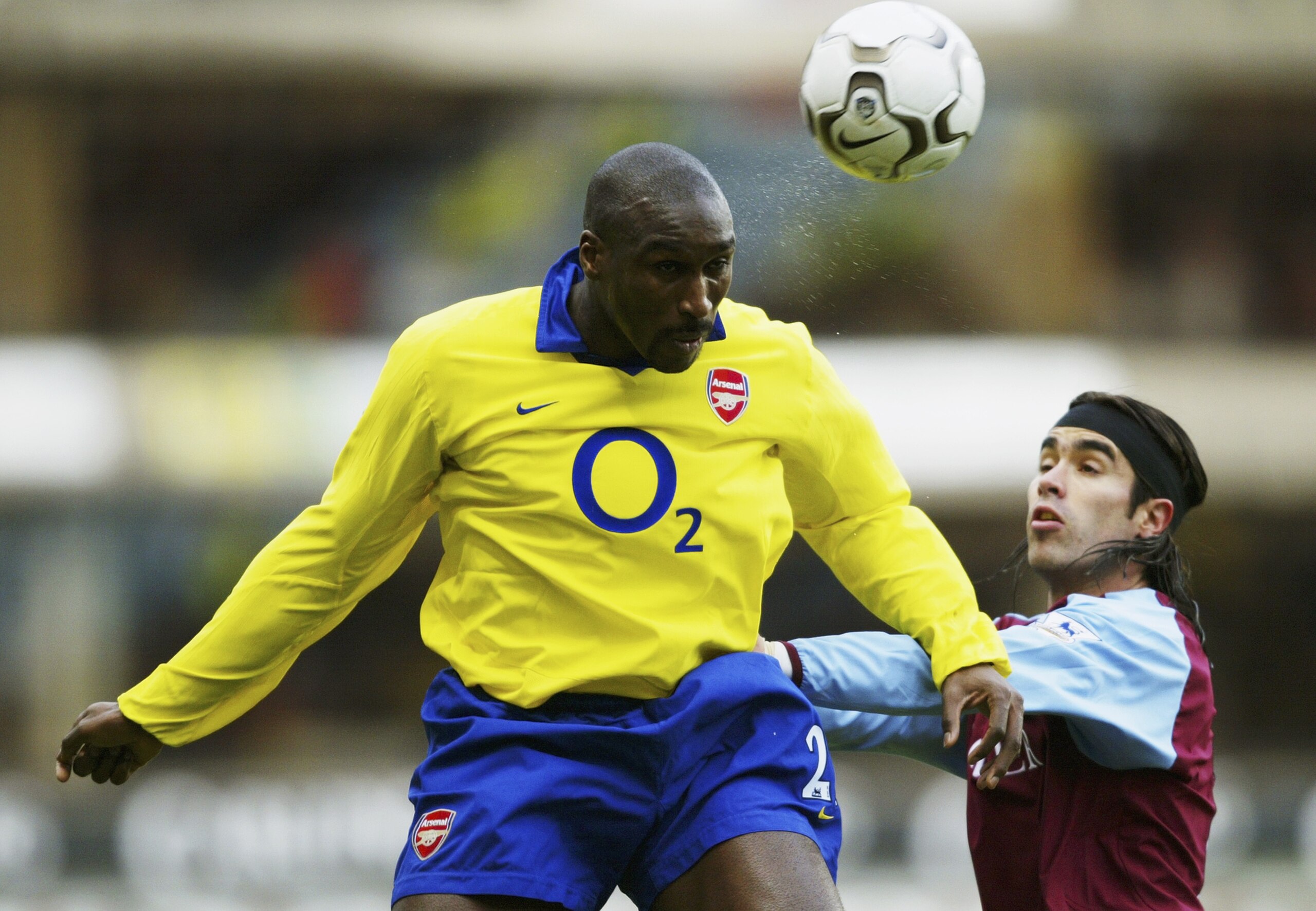 BIRMINGHAM, ENGLAND - JANUARY 18:  Juan Pablo Angel of Aston Villa and Sol Campbell  jump for ball during the FA Barclaycard Premiership match between Aston Villa and Arsenal at Villa Park on January 18, 2004 in Birmingham, England.  (Photo by Shaun Botte