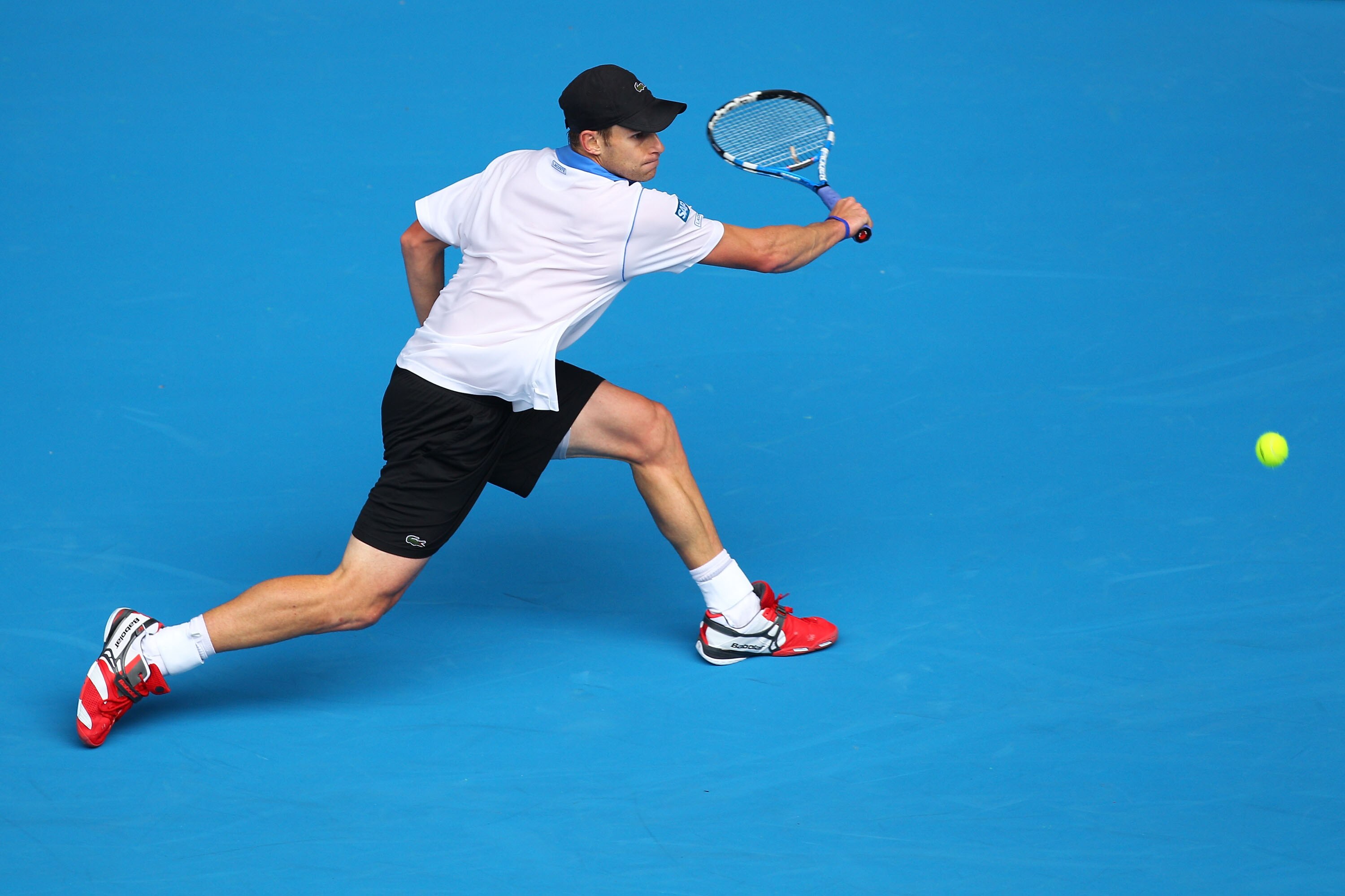 MELBOURNE, AUSTRALIA - JANUARY 17:  Andy Roddick of the United States of America plays a backhand in his first round match against Jan Hajek of the Czech Republic during day one of the 2011 Australian Open at Melbourne Park on January 17, 2011 in Melbourn