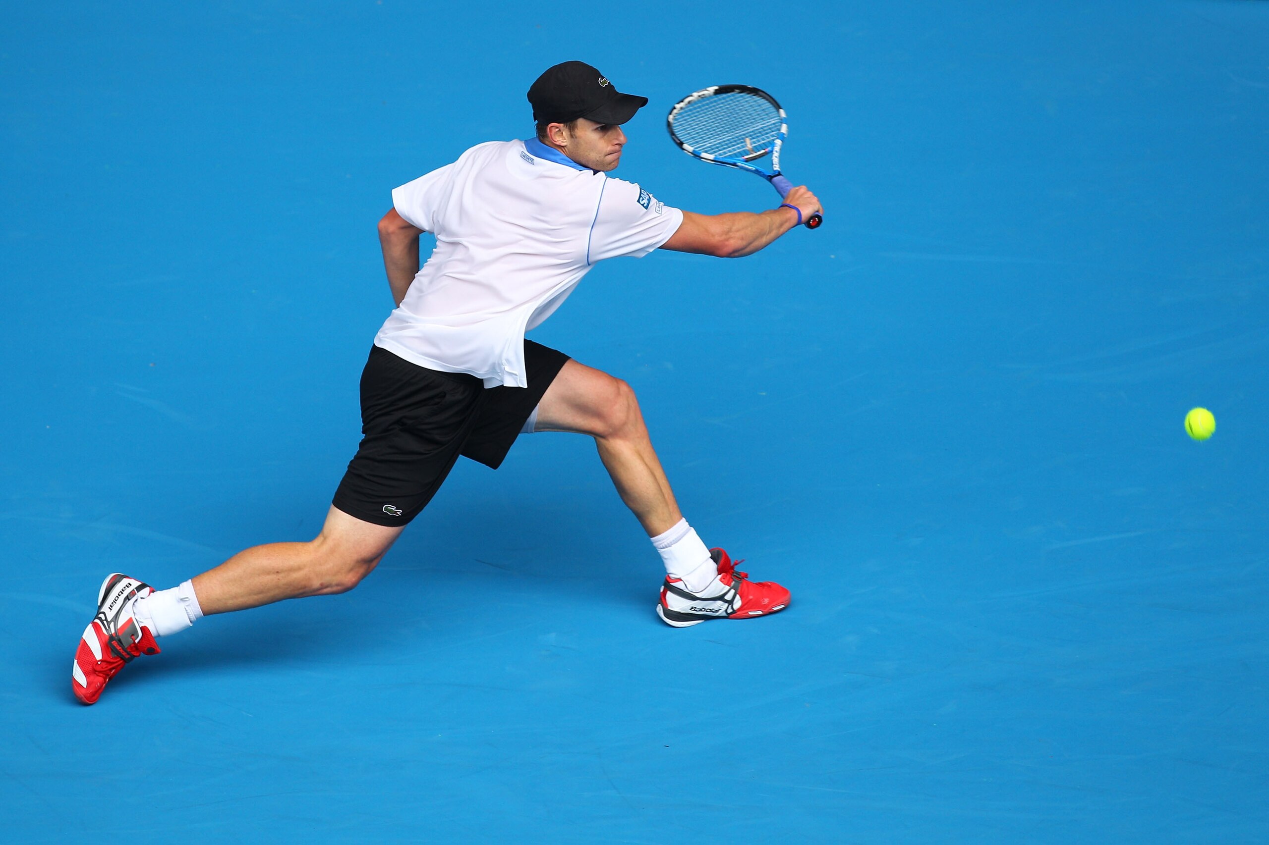 MELBOURNE, AUSTRALIA - JANUARY 17:  Andy Roddick of the United States of America plays a backhand in his first round match against Jan Hajek of the Czech Republic during day one of the 2011 Australian Open at Melbourne Park on January 17, 2011 in Melbourn