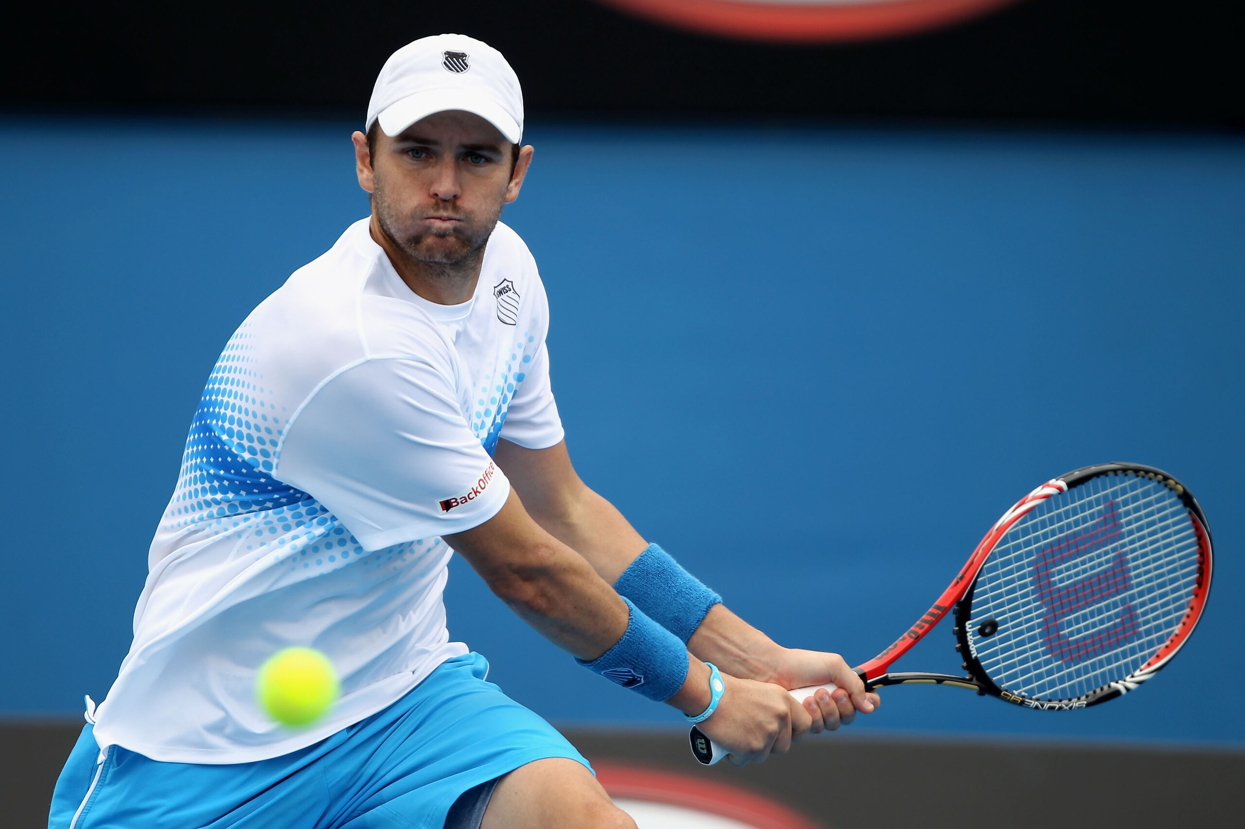 MELBOURNE, AUSTRALIA - JANUARY 17:  Mardy Fish of the USA plays a backhand in his first round match against Victor Hanescu of Romania during day one of the 2011 Australian Open at Melbourne Park on January 17, 2011 in Melbourne, Australia.  (Photo by Cliv