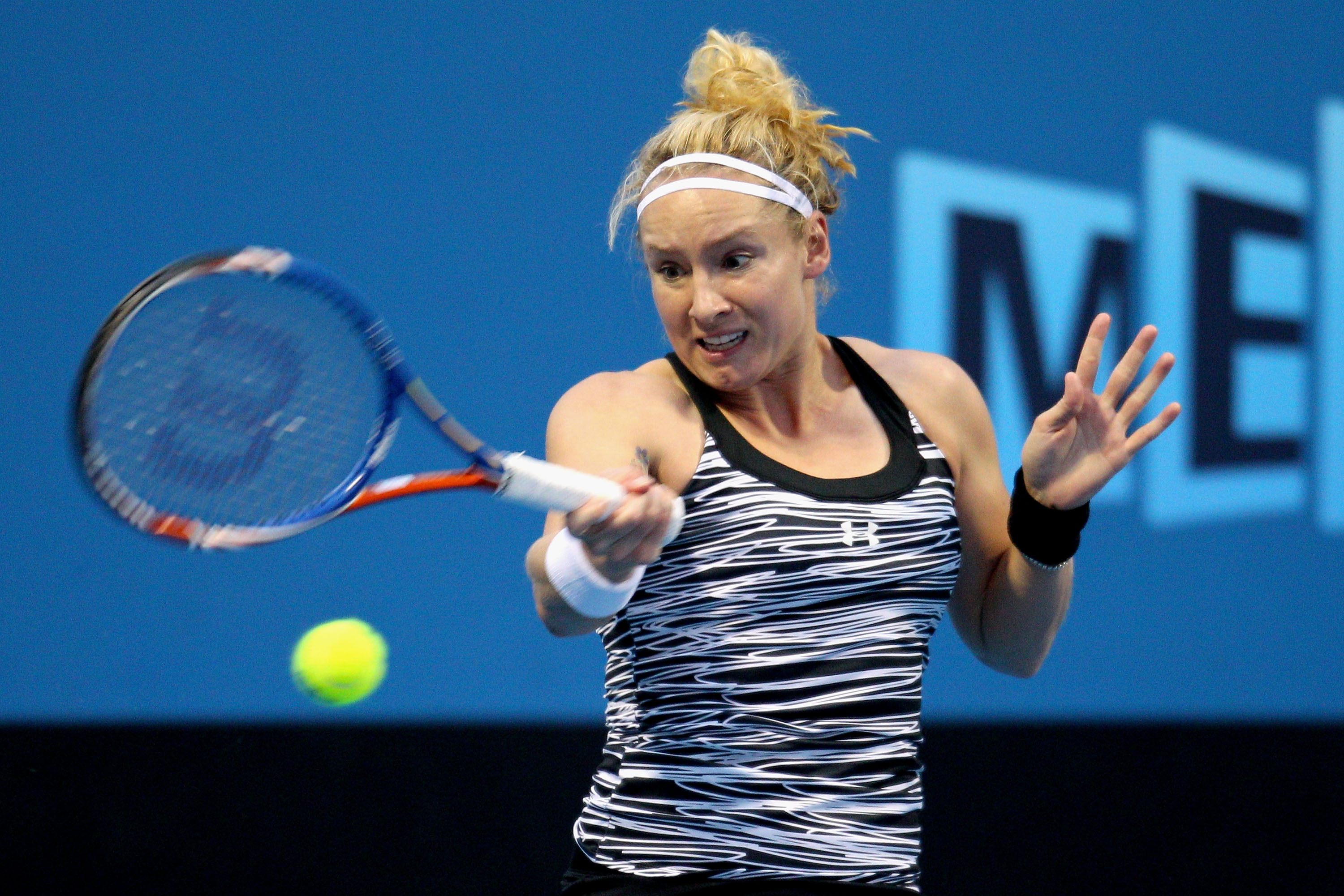MELBOURNE, AUSTRALIA - JANUARY 17:  Bethanie Mattek-Sands of the USA plays a backhand in her first round match against  Arantxa Rus of The Netherlands during day one of the 2011 Australian Open at Melbourne Park on January 17, 2011 in Melbourne, Australia
