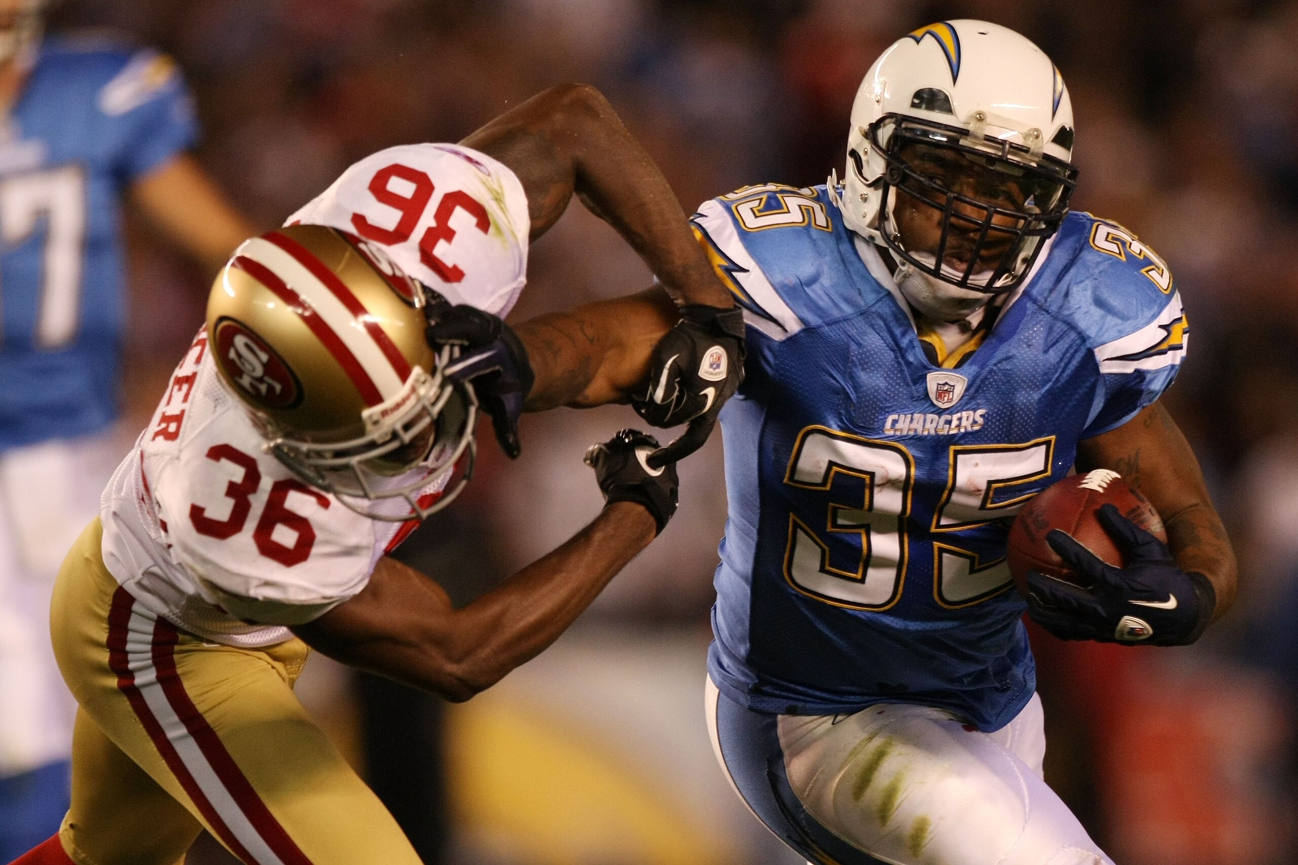 SAN DIEGO, CA - DECEMBER 16:  Running back Mike Tolbert #35 of the San Diego Chargers rushes with the ball as cornerback Shawntae Spencer #36 of the San Francisco 49ers trys to tackle him at Qualcomm Stadium on December 16, 2010 in San Diego, California. 