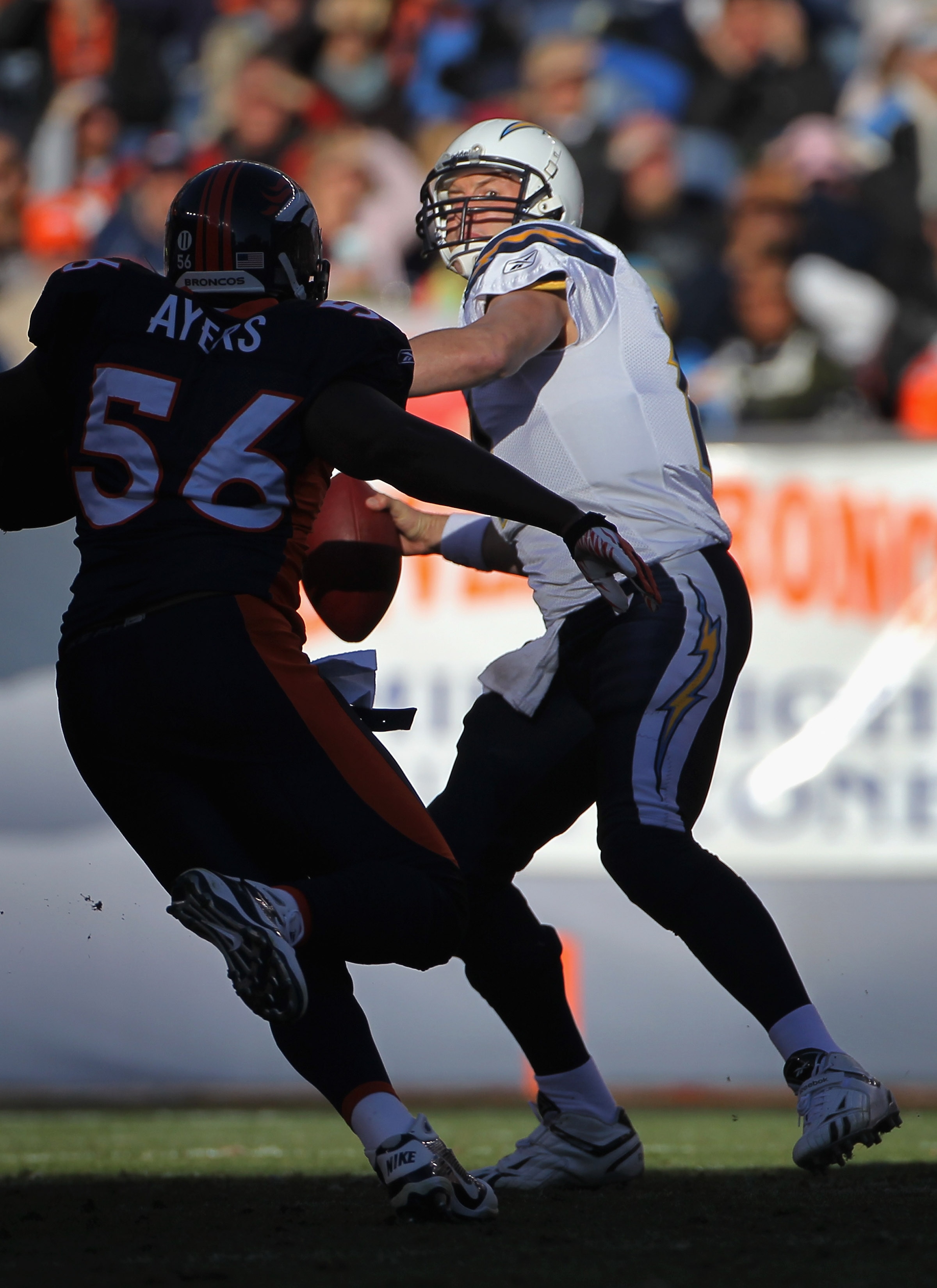 DENVER - JANUARY 02:  Quarterback Philip Rivers #17 of the San Diego Chargers looks to deliver a pass against linebacker Robert Ayers #56 of the Denver Broncos at INVESCO Field at Mile High on January 2, 2011 in Denver, Colorado. The Chargers defeated the