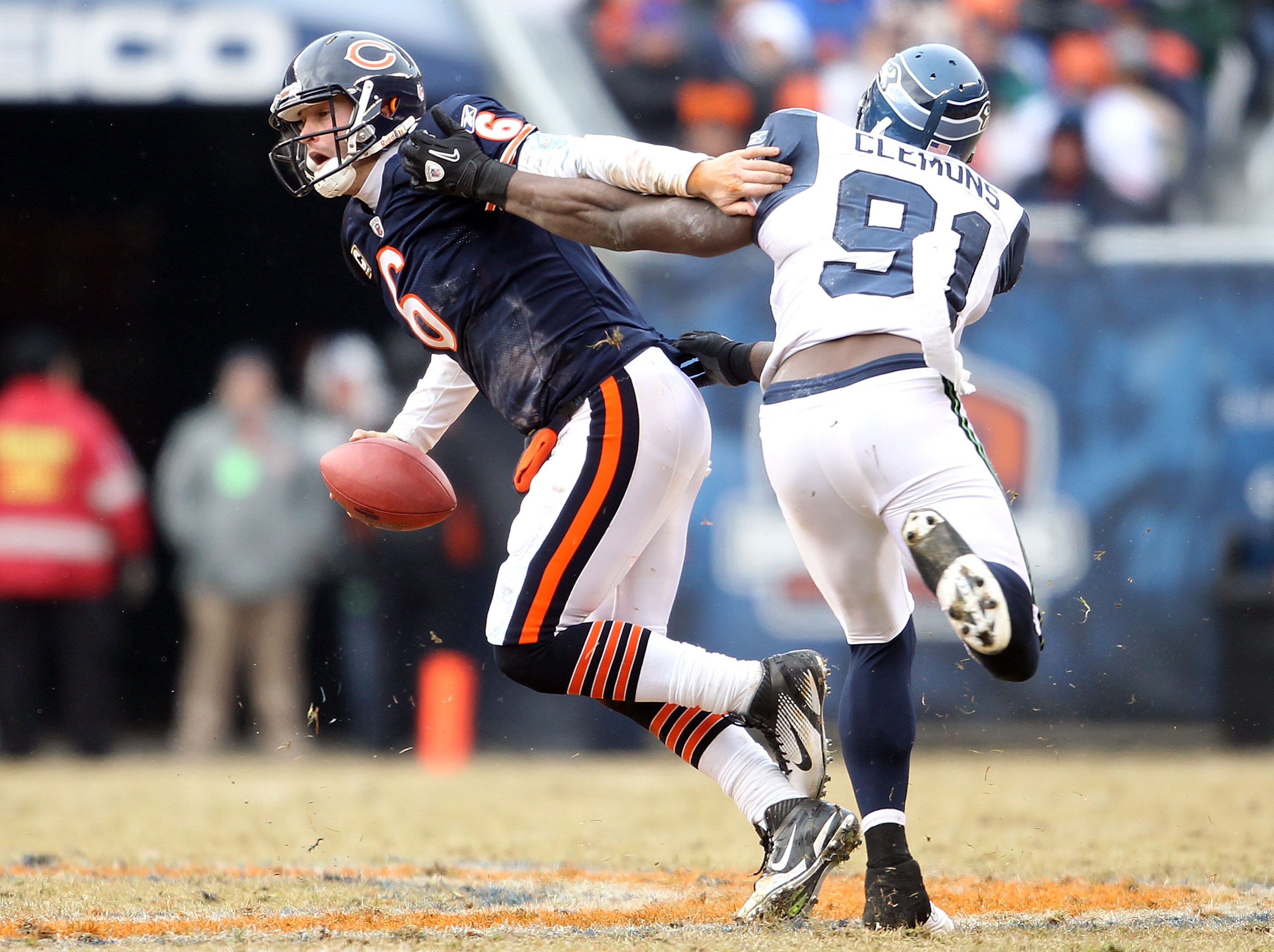CHICAGO, IL - JANUARY 16:  Quarterback Jay Cutler #6 of the Chicago Bears attempts to avoid a sack by Chris Clemons #91 of the Seattle Seahawks in the second half of the 2011 NFC divisional playoff game at Soldier Field on January 16, 2011 in Chicago, Ill