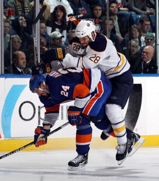 UNIONDALE, NY - JANUARY 15: Paul Gaustad #28 of the Buffalo Sabres runs into Radek Martinek #24 of the New York Islanders at the Nassau Coliseum on January 15, 2011 in Uniondale, New York. The Islanders defeated the Sabres 5-3. (Photo by Bruce Bennett/Get