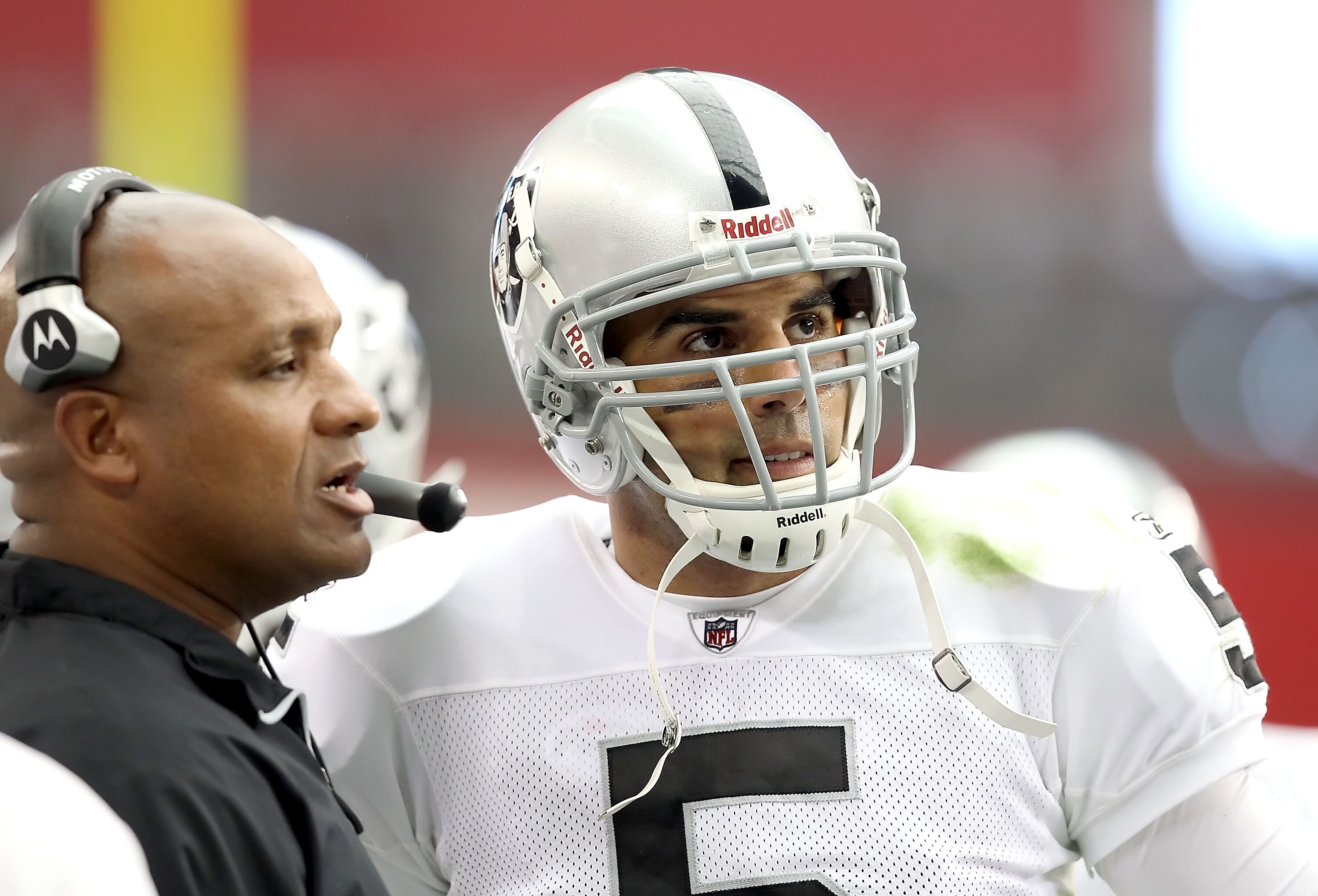 GLENDALE, AZ - SEPTEMBER 26:  Quarterback Bruce Gradkowski #5 of the Oakland Raiders talks with offensive coordinator Hue Jackson during the NFL game against the Arizona Cardinals at the University of Phoenix Stadium on September 26, 2010 in Glendale, Ari