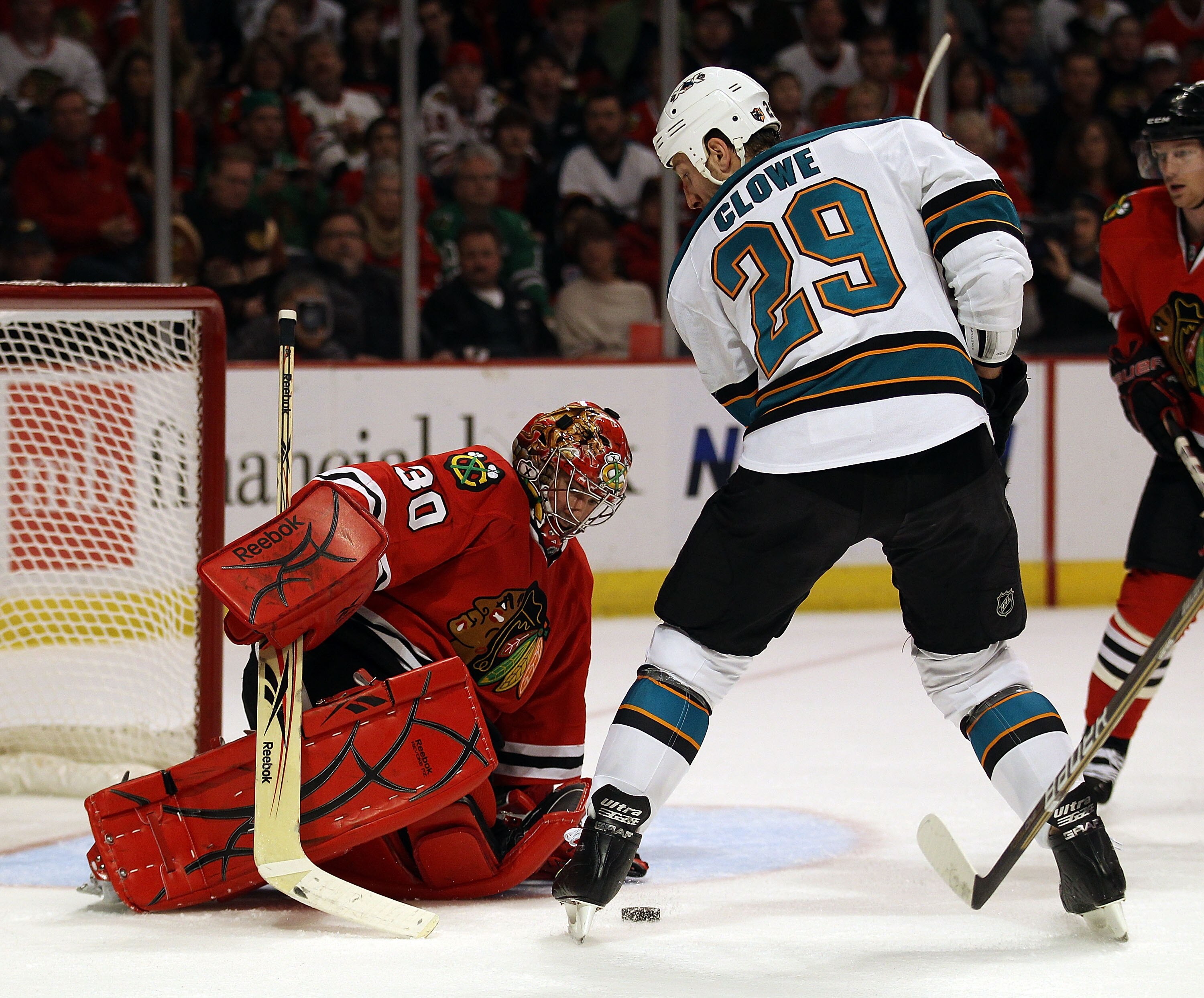 CHICAGO, IL - DECEMBER 30: Marty Turco #30 of the Chicago Blackhawks makes a save against Ryane Clowe #29 of the San Jose Sharks at the United Center on December 30, 2010 in Chicago, Illinois.  The Sarks defeated the Blackhawks 5-3. (Photo by Jonathan Dan