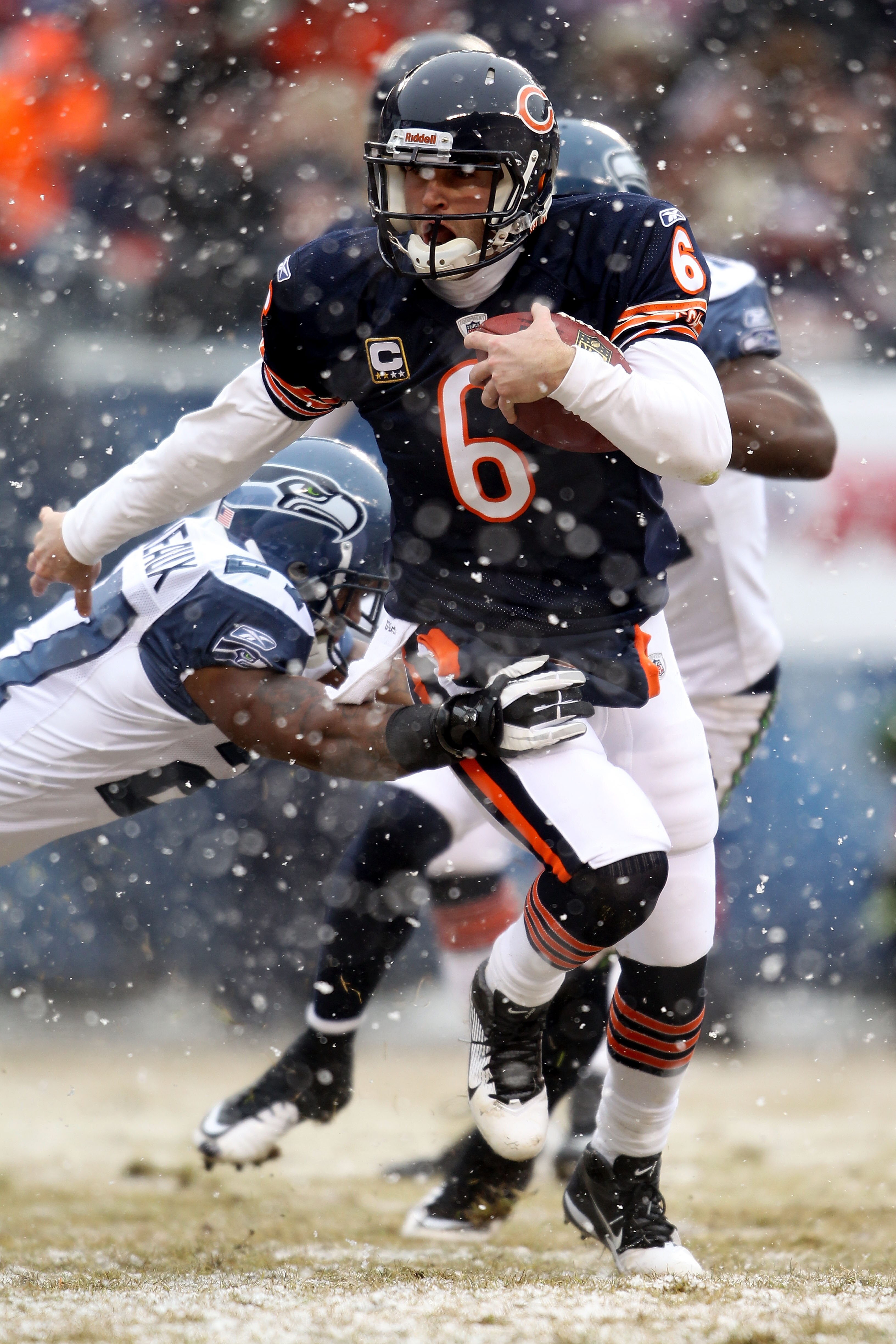 CHICAGO, IL - JANUARY 16:  Quarterback Jay Cutler #6 of the Chicago Bears runs the ball to score on a six-yard touchdown against the Seattle Seahawks in the second quarter of the 2011 NFC divisional playoff game at Soldier Field on January 16, 2011 in Chi