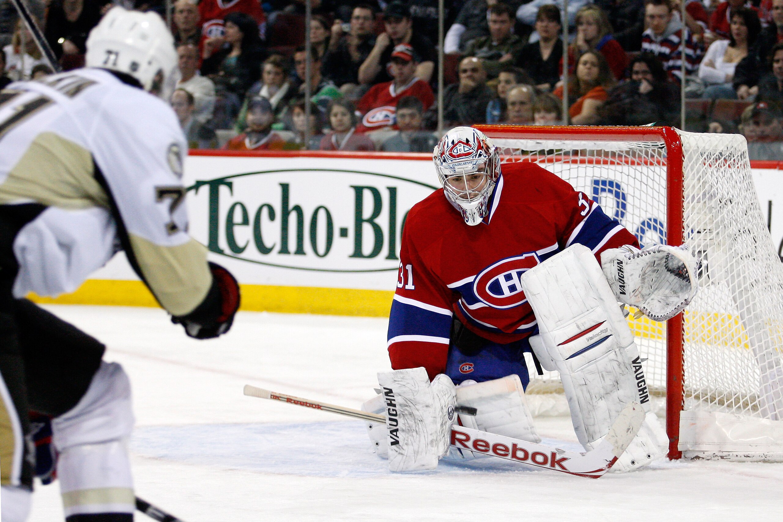 MONTREAL, CANADA - JANUARY 12:  Carey Price #31 of the Montreal Canadiens gets down to stop the incoming puck on a shot by Evgeni Malkin #71 of the Pittsburgh Penguins during the NHL game at the Bell Centre on January 12, 2011 in Montreal, Quebec, Canada.